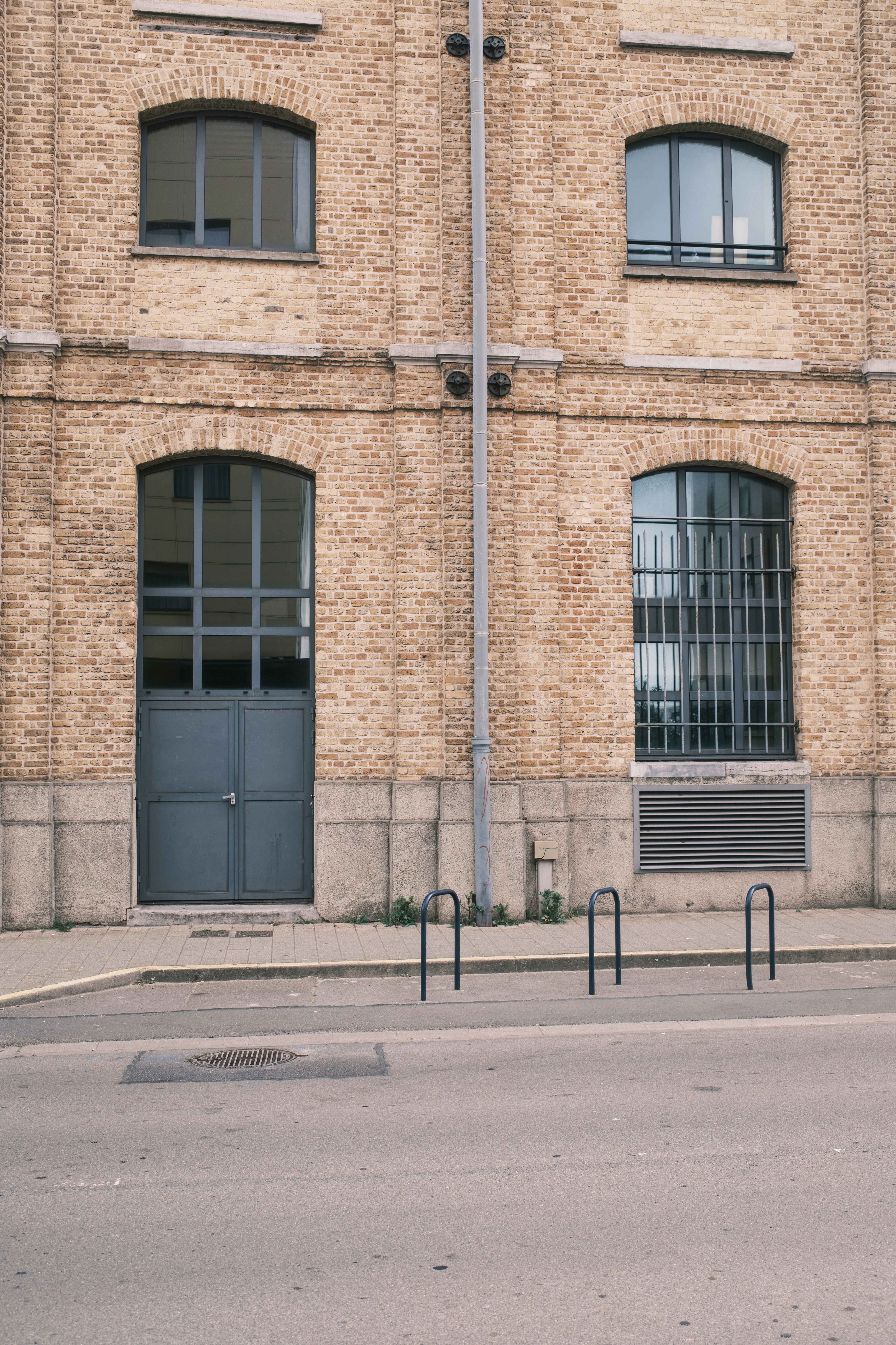 A brick building features doors and windows.