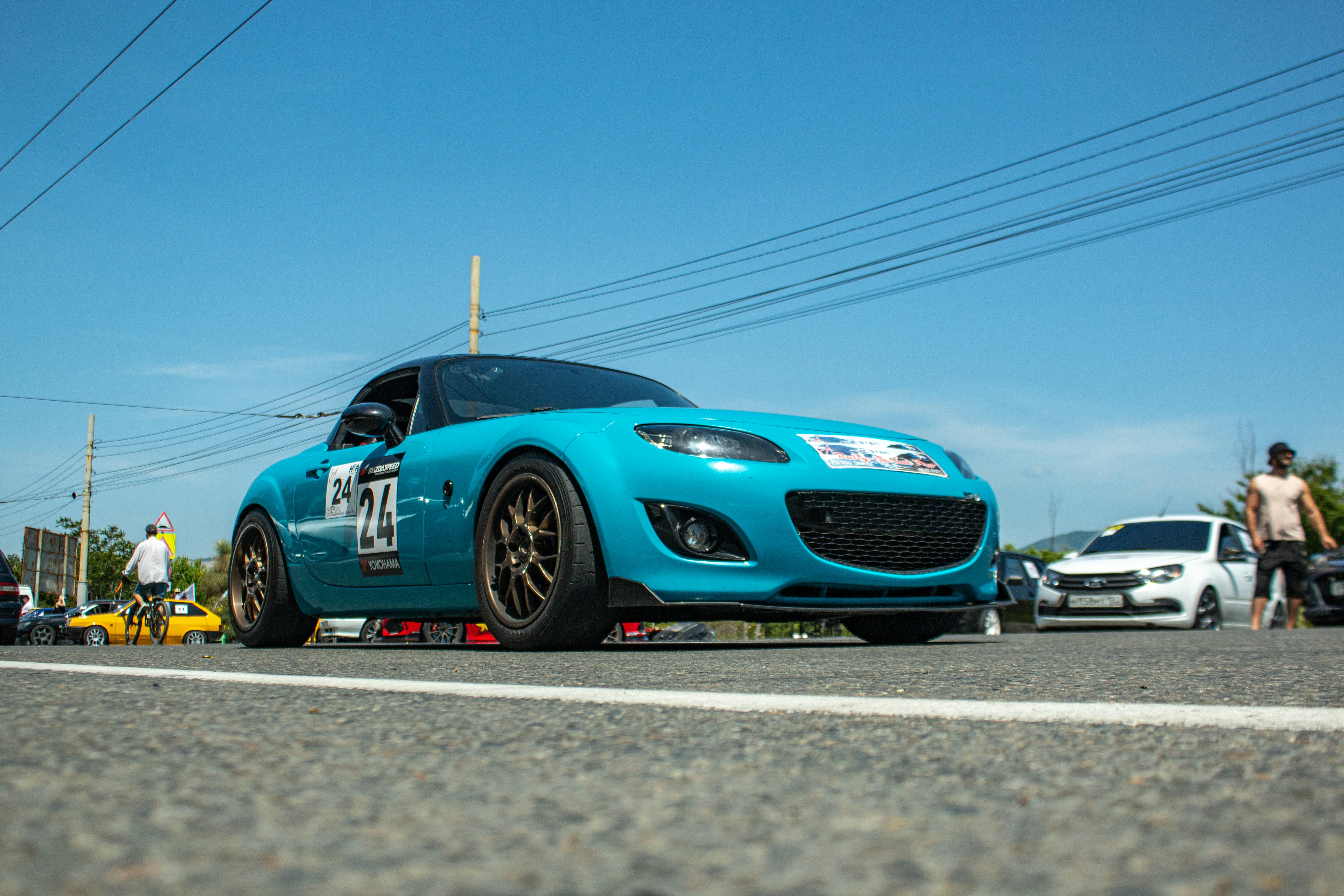 A blue sports car is parked on the road.