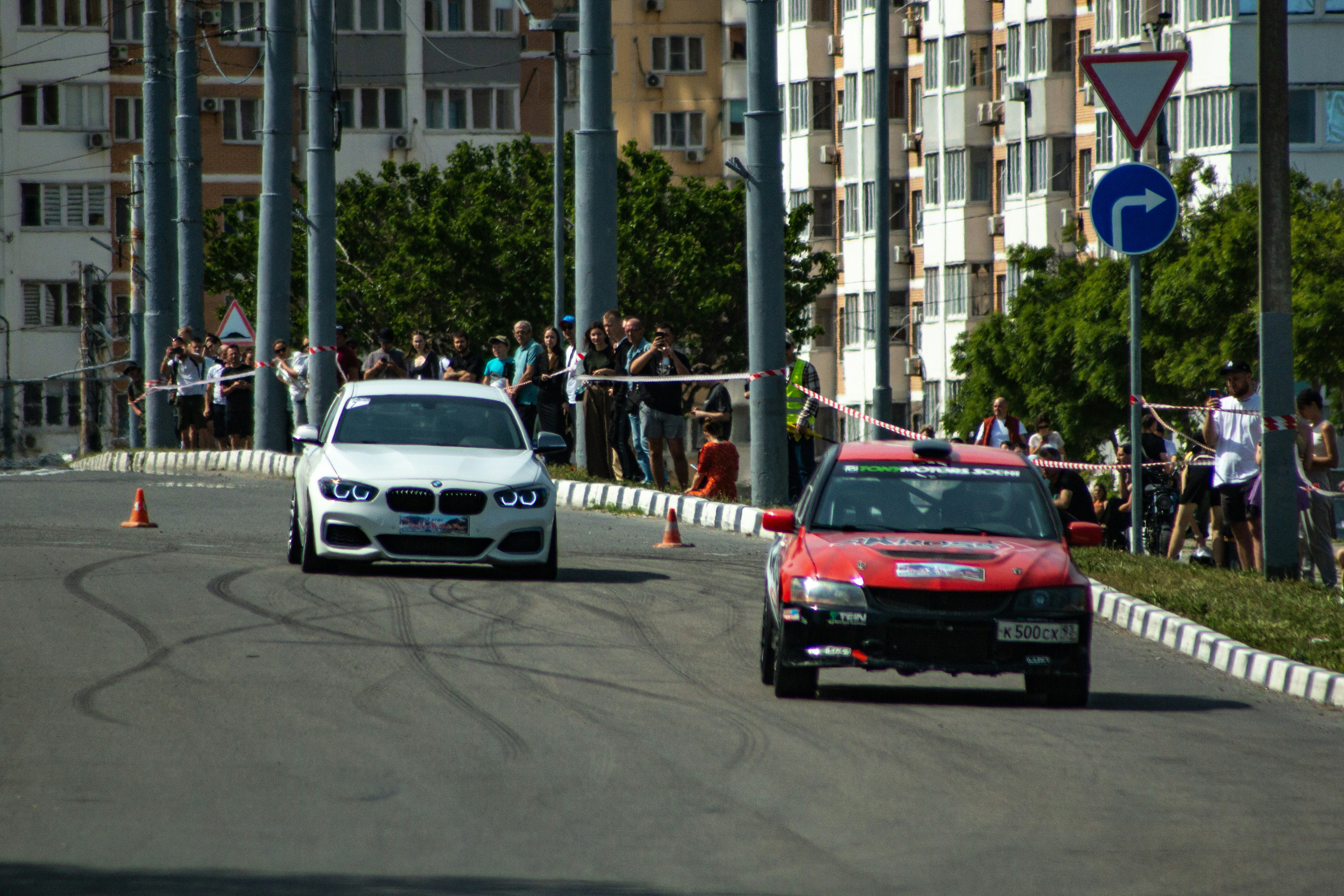 Two cars race on a city street.