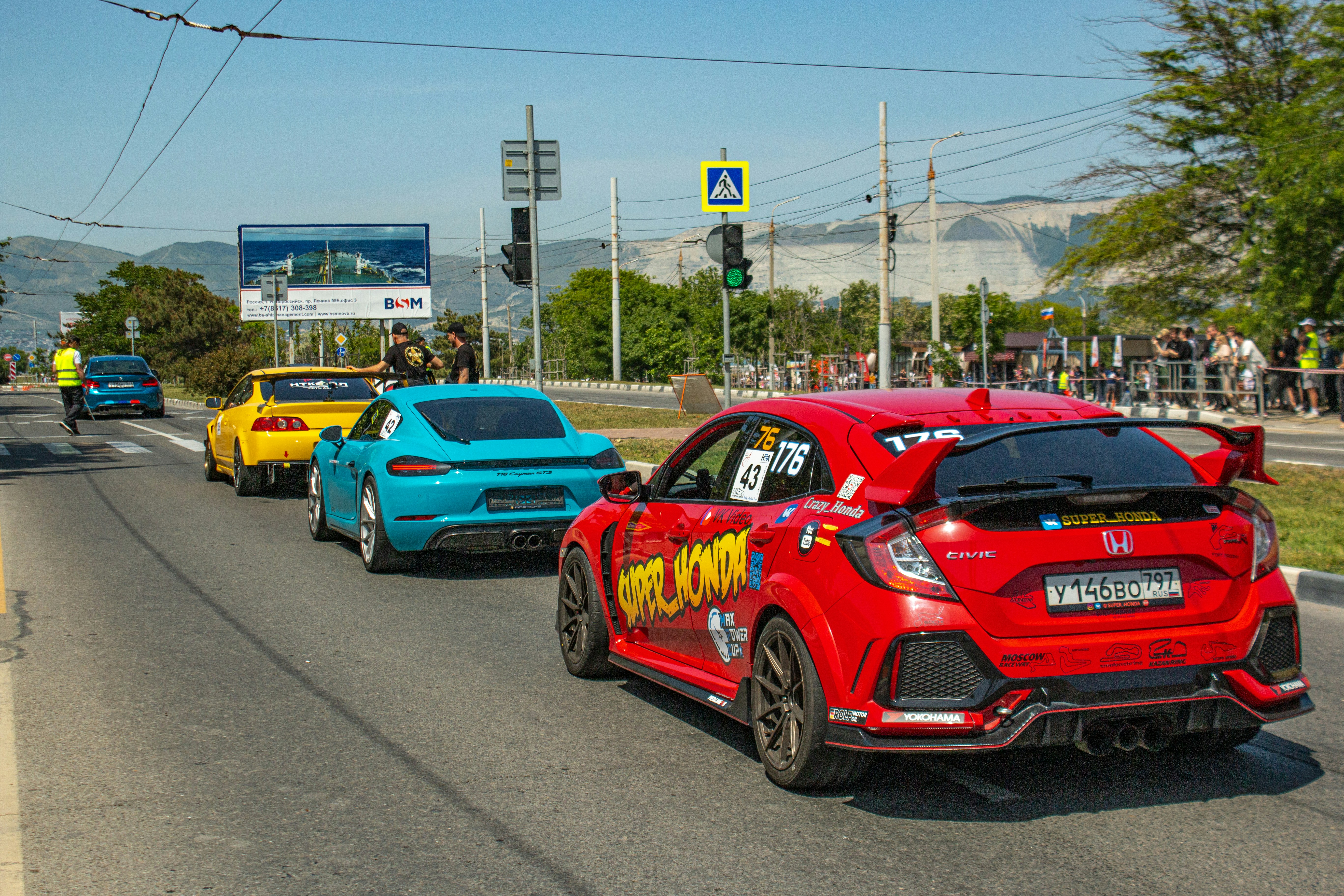 Cars driving on a road during a race.