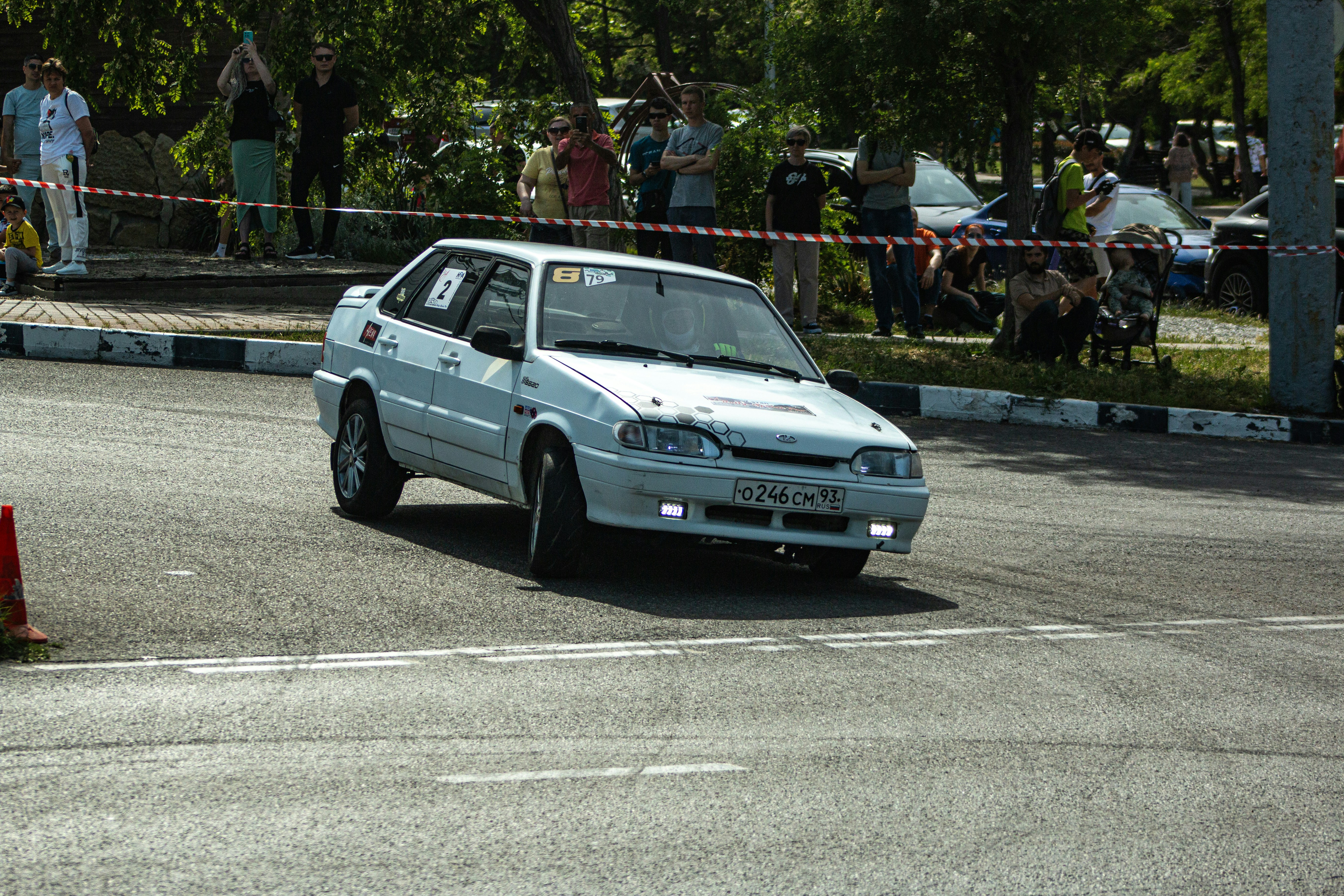 A white car races down a track.