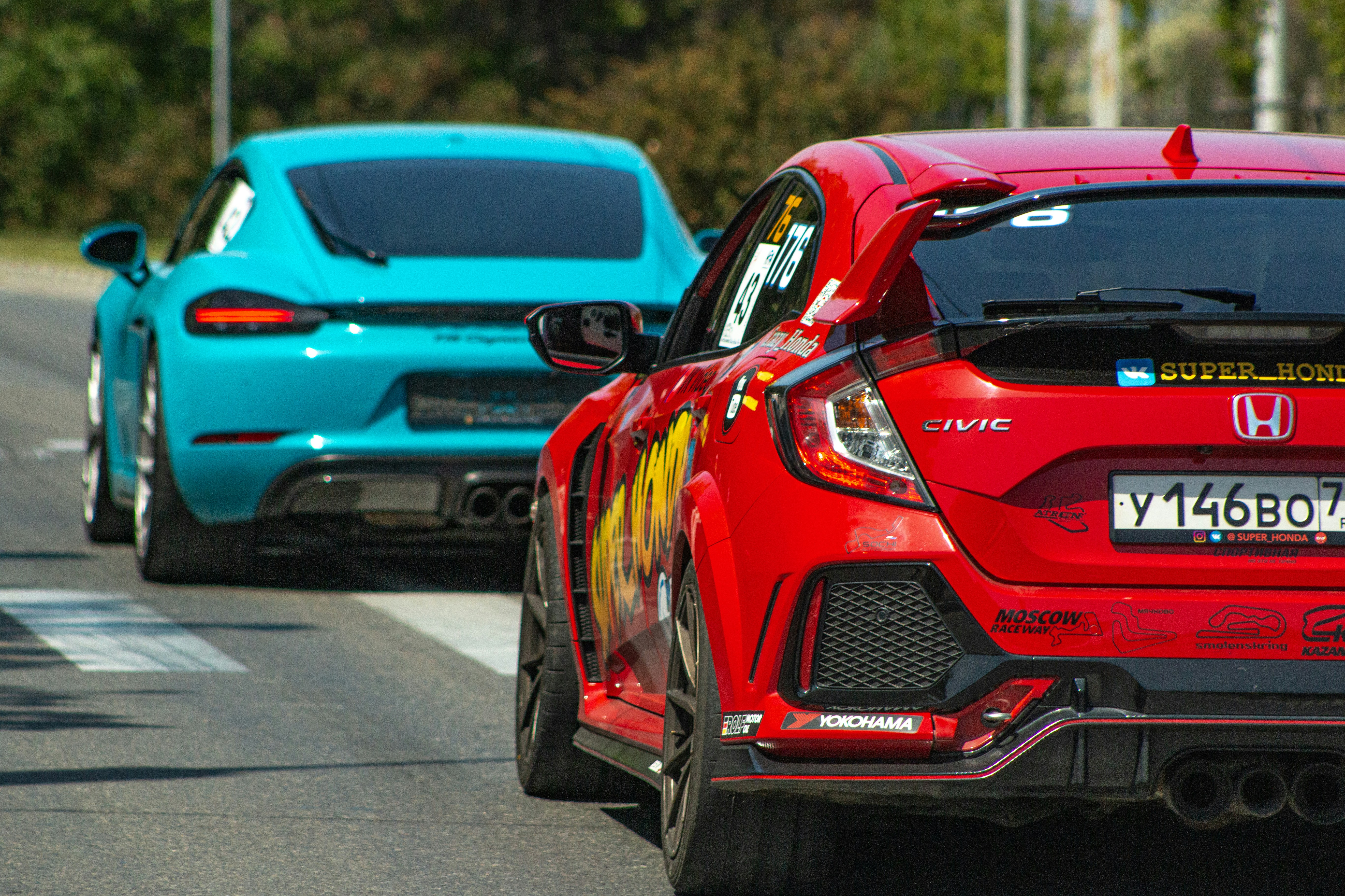 Two cars are driving on the road.
