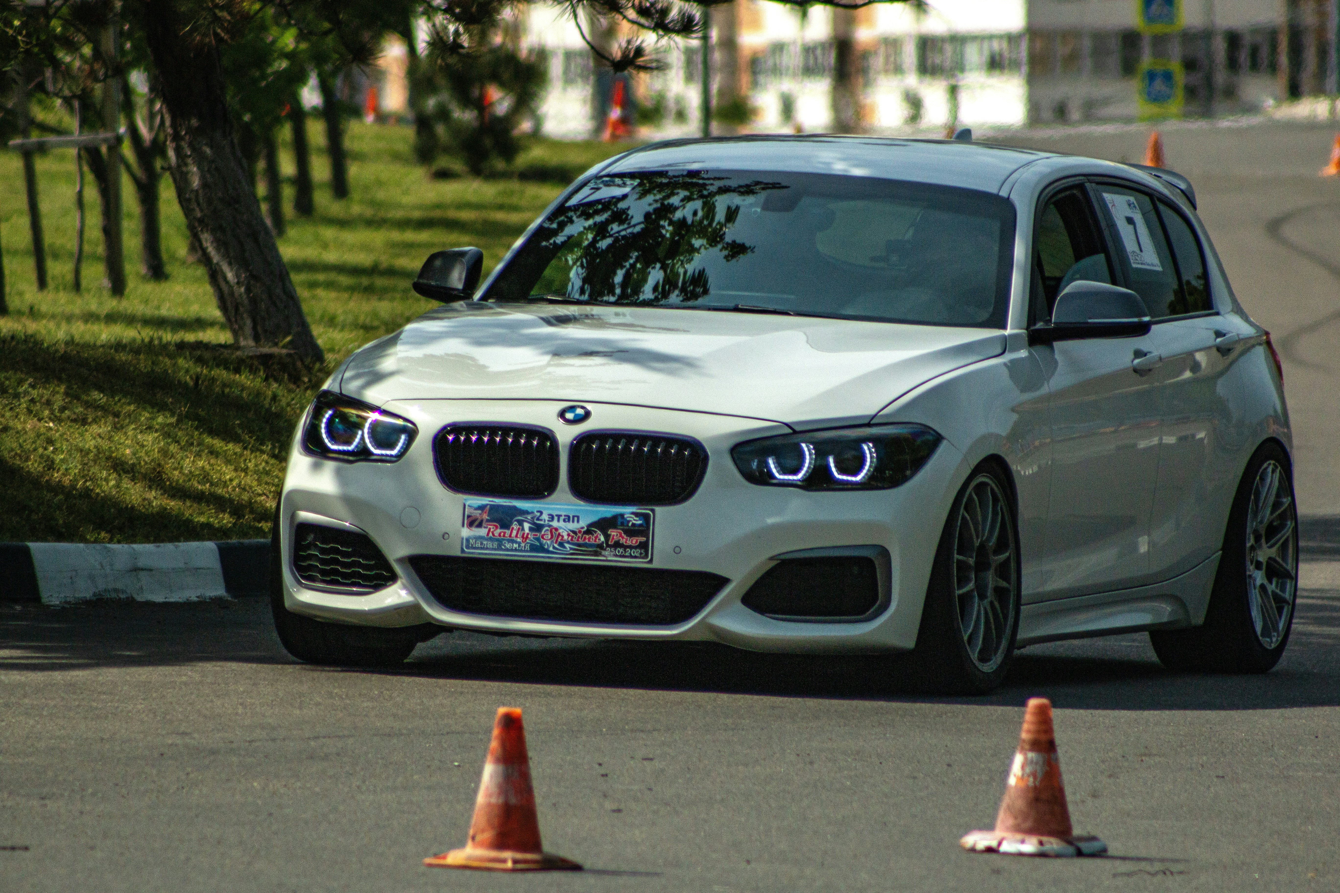 A white BMW sits on the road with cones. photo – Free Car Image on Unsplash