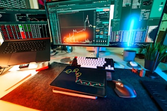 A trader's desk is lit up with charts.