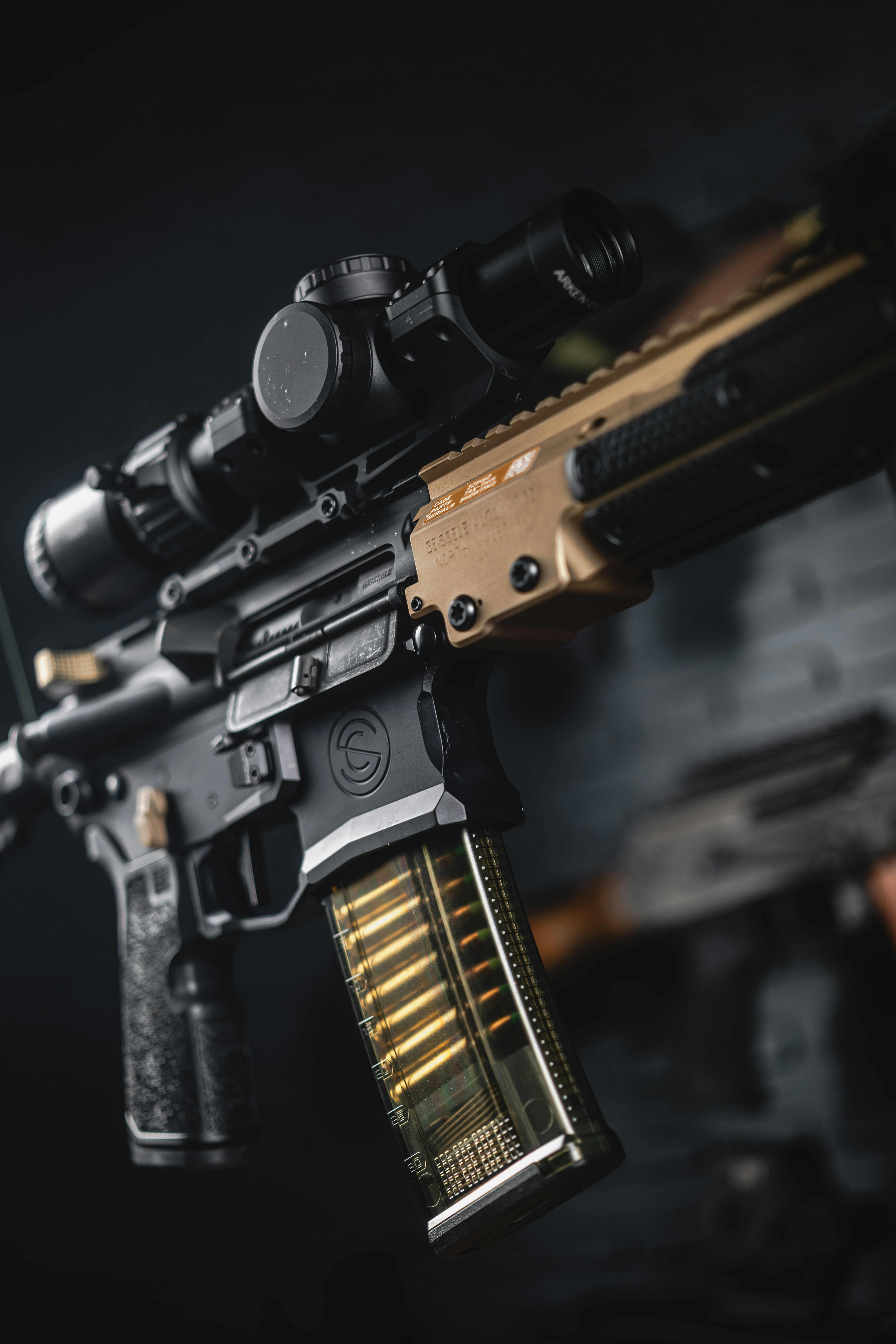 An assault rifle is shown with a scope.