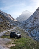 Off-road vehicle parked in a mountainous landscape.
