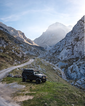 Off-road vehicle parked in a mountainous landscape.