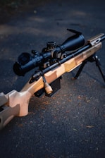 A camouflaged sniper rifle with scope.