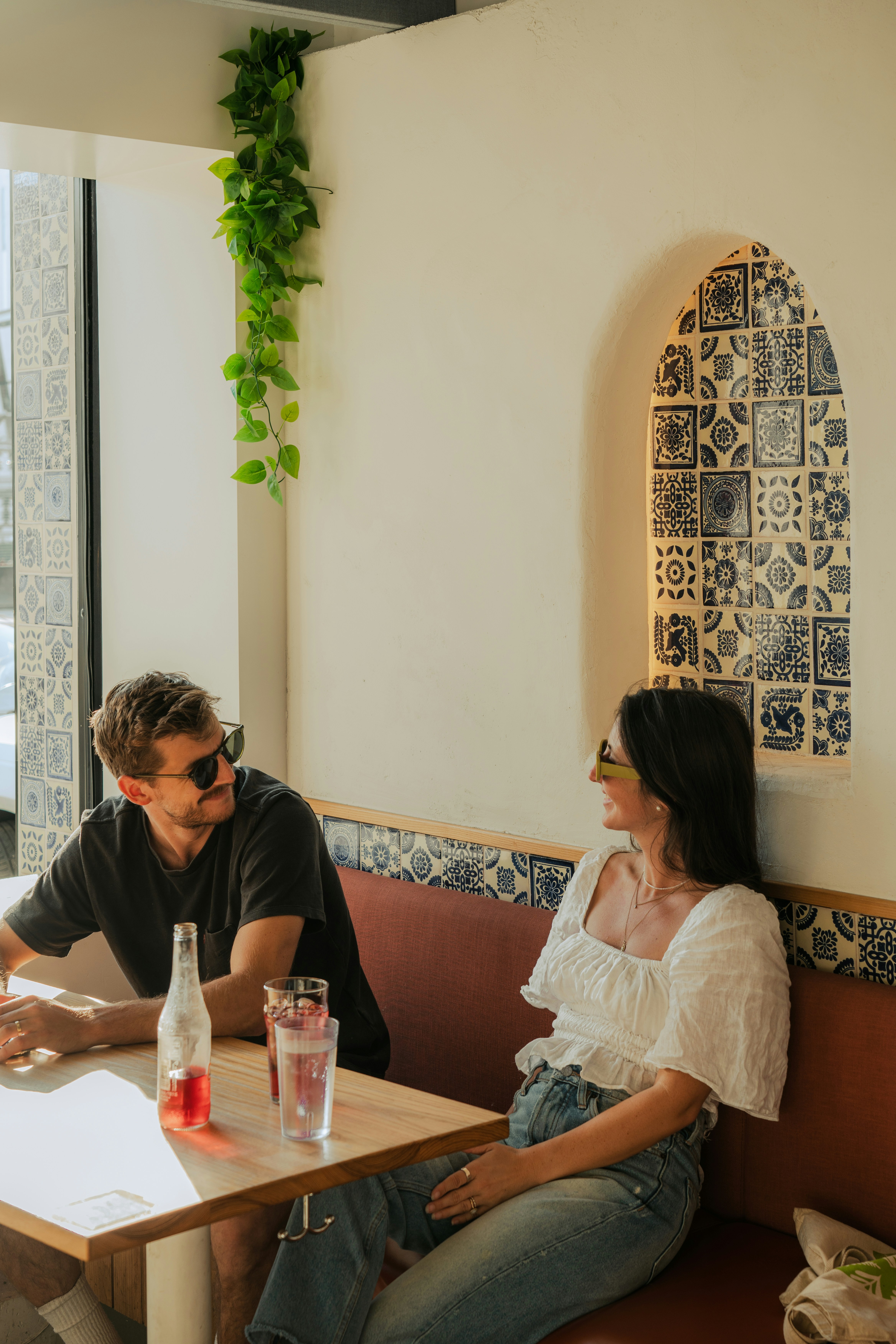 Couple chatting in a stylish, brightly lit cafe.