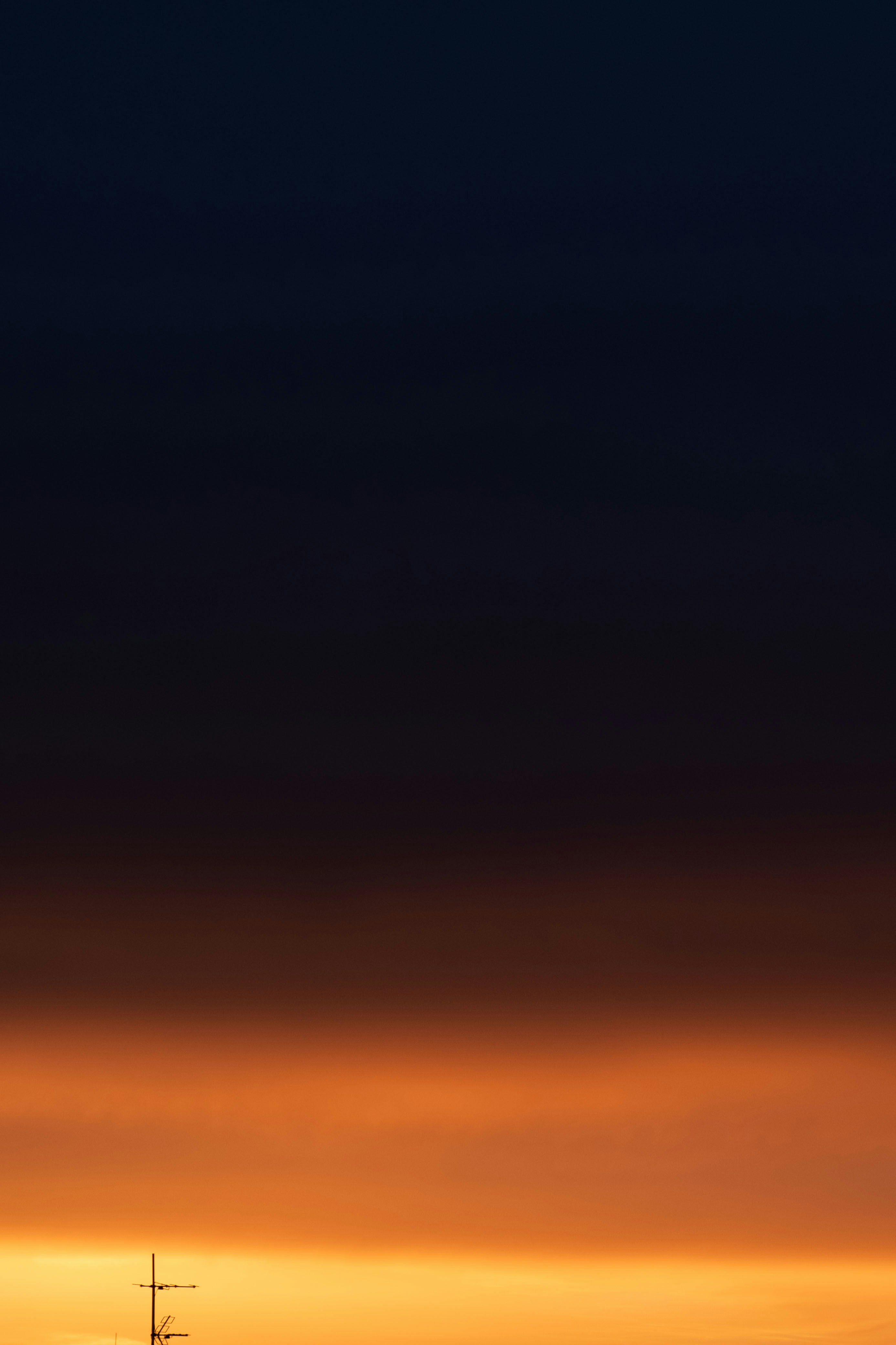 Orange and dark blue sky at dusk.