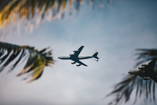 An airplane flies through a clear sky.