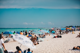 People relax and enjoy the beach on a sunny day.