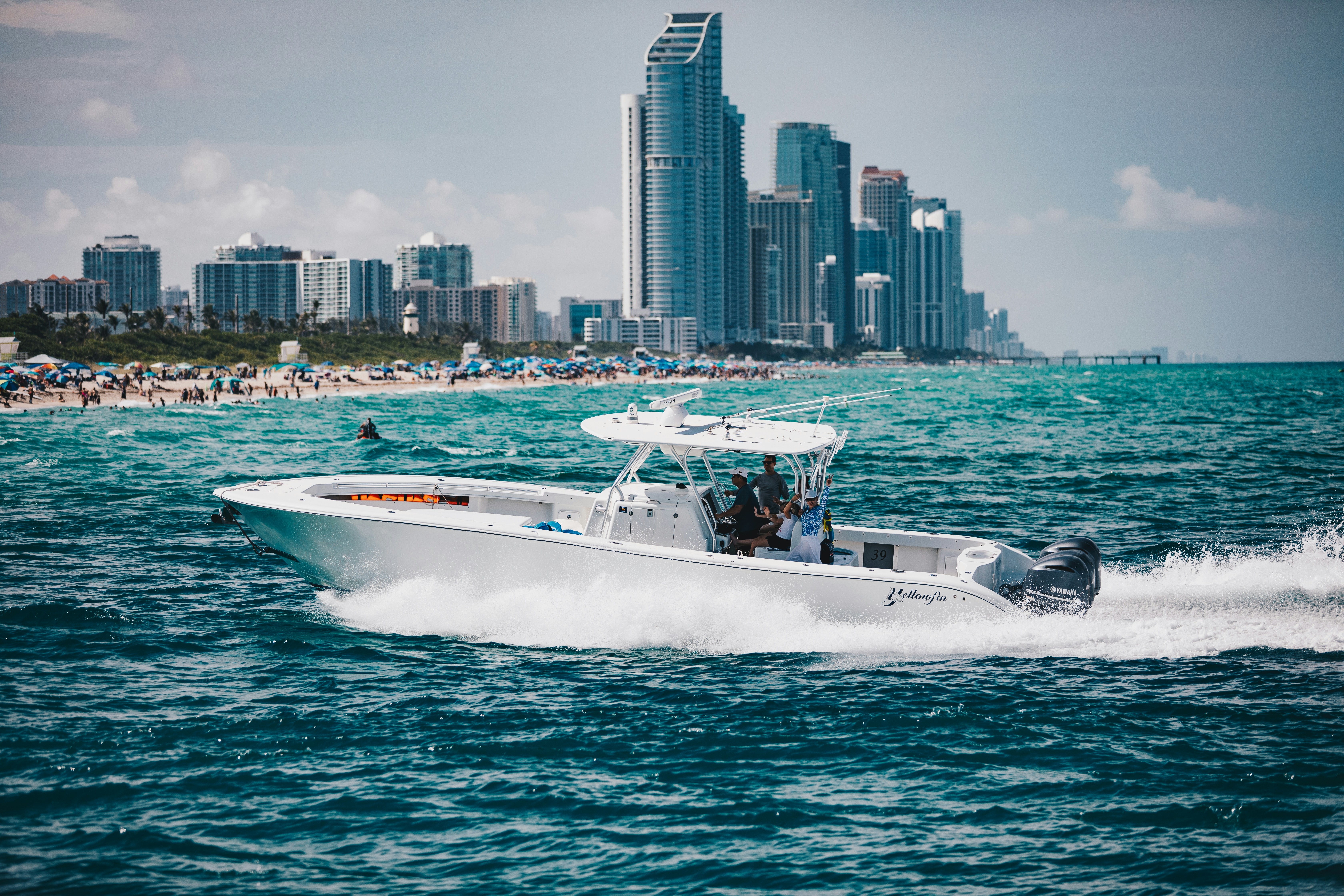 A boat cruises past a city skyline