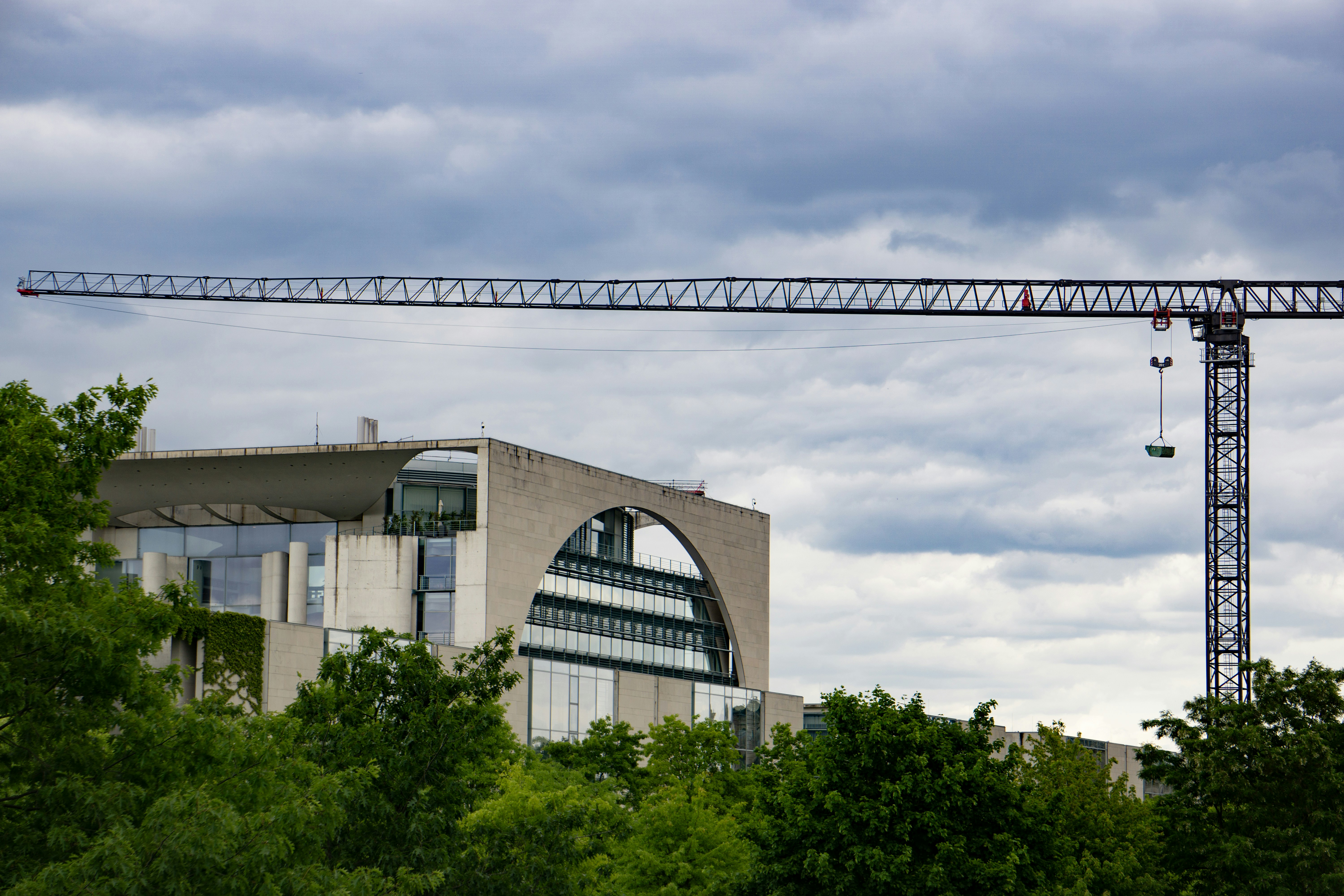 A crane stands above a modern building.
