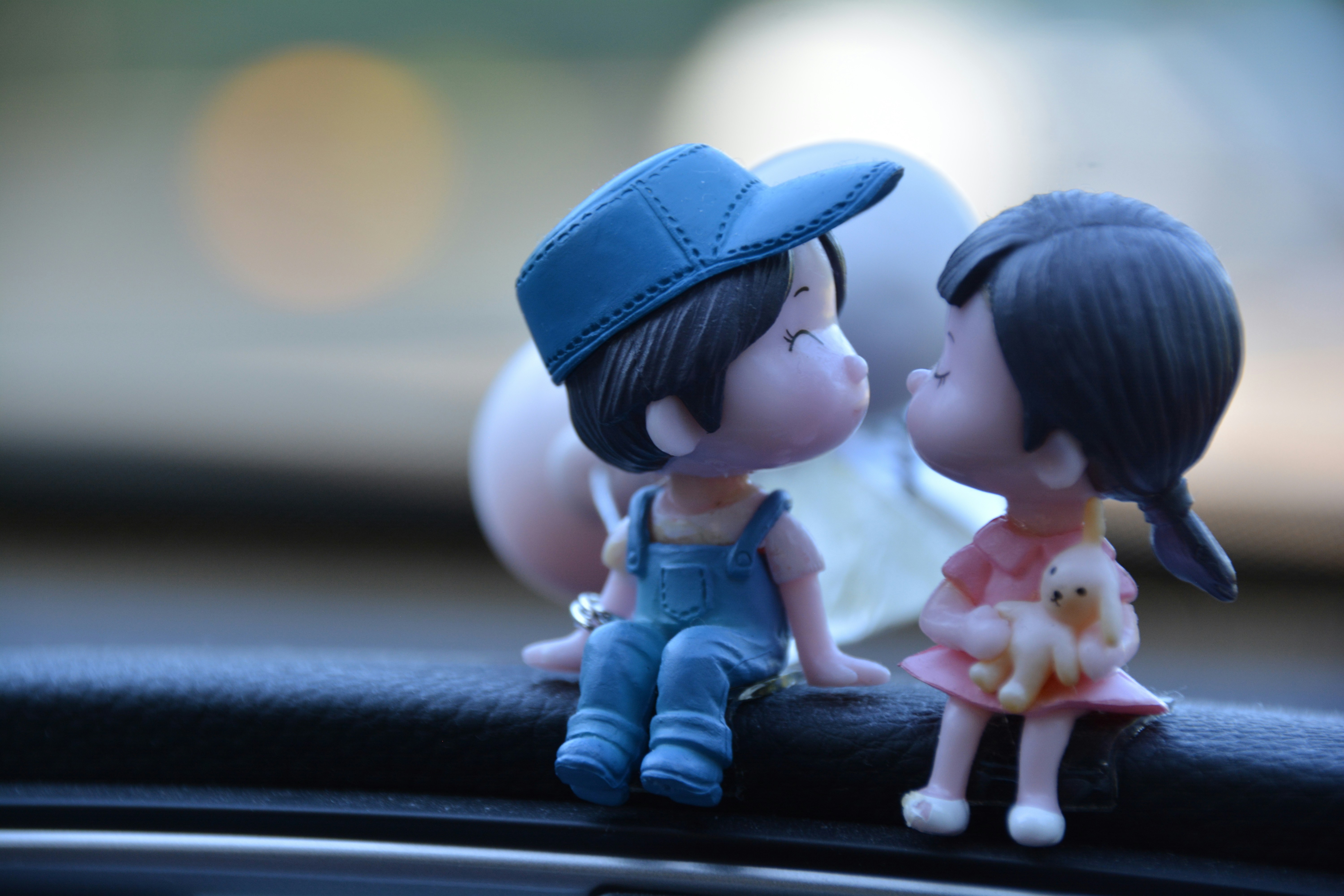 Cute figurines are about to share a kiss.