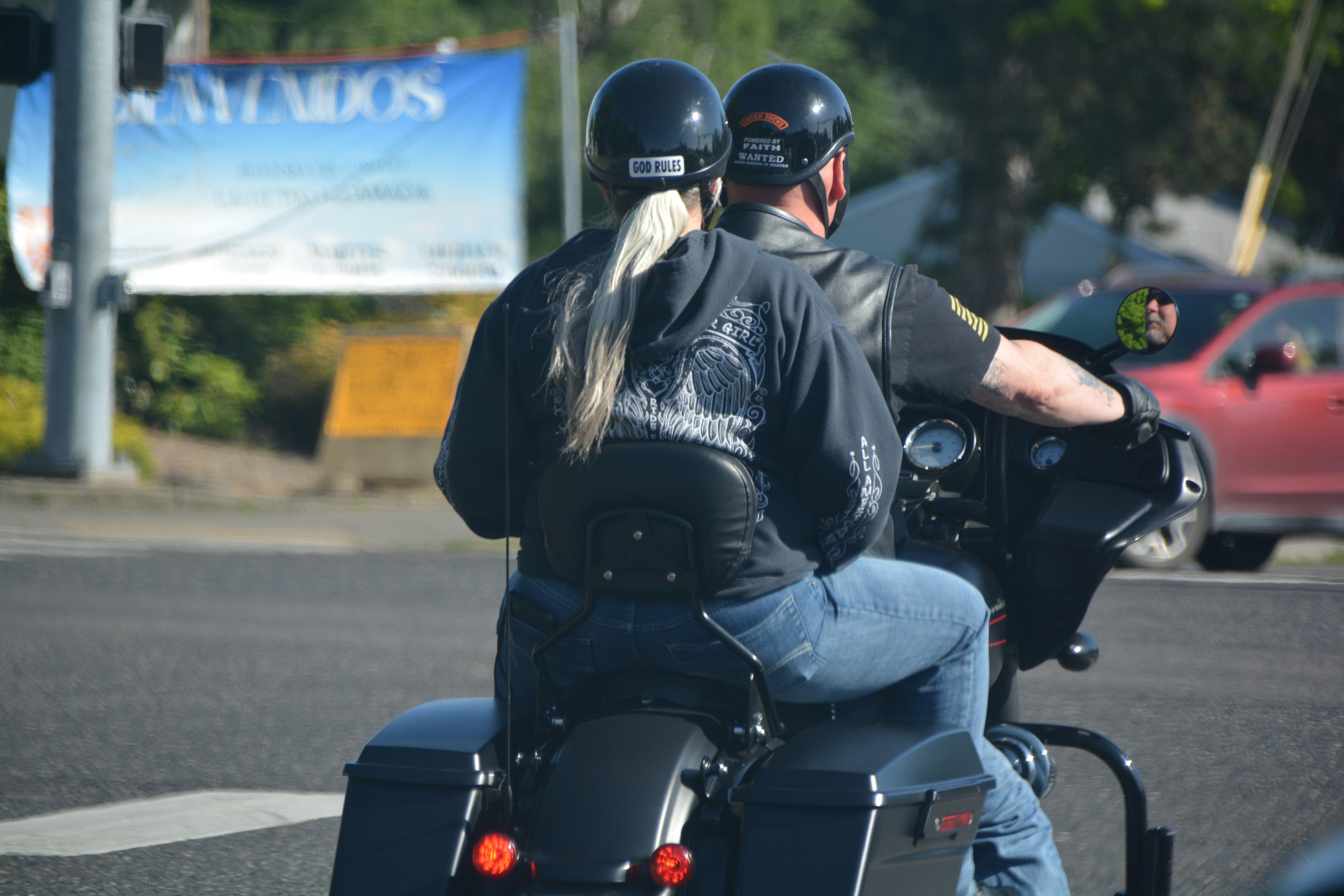 Two people ride a motorcycle together.