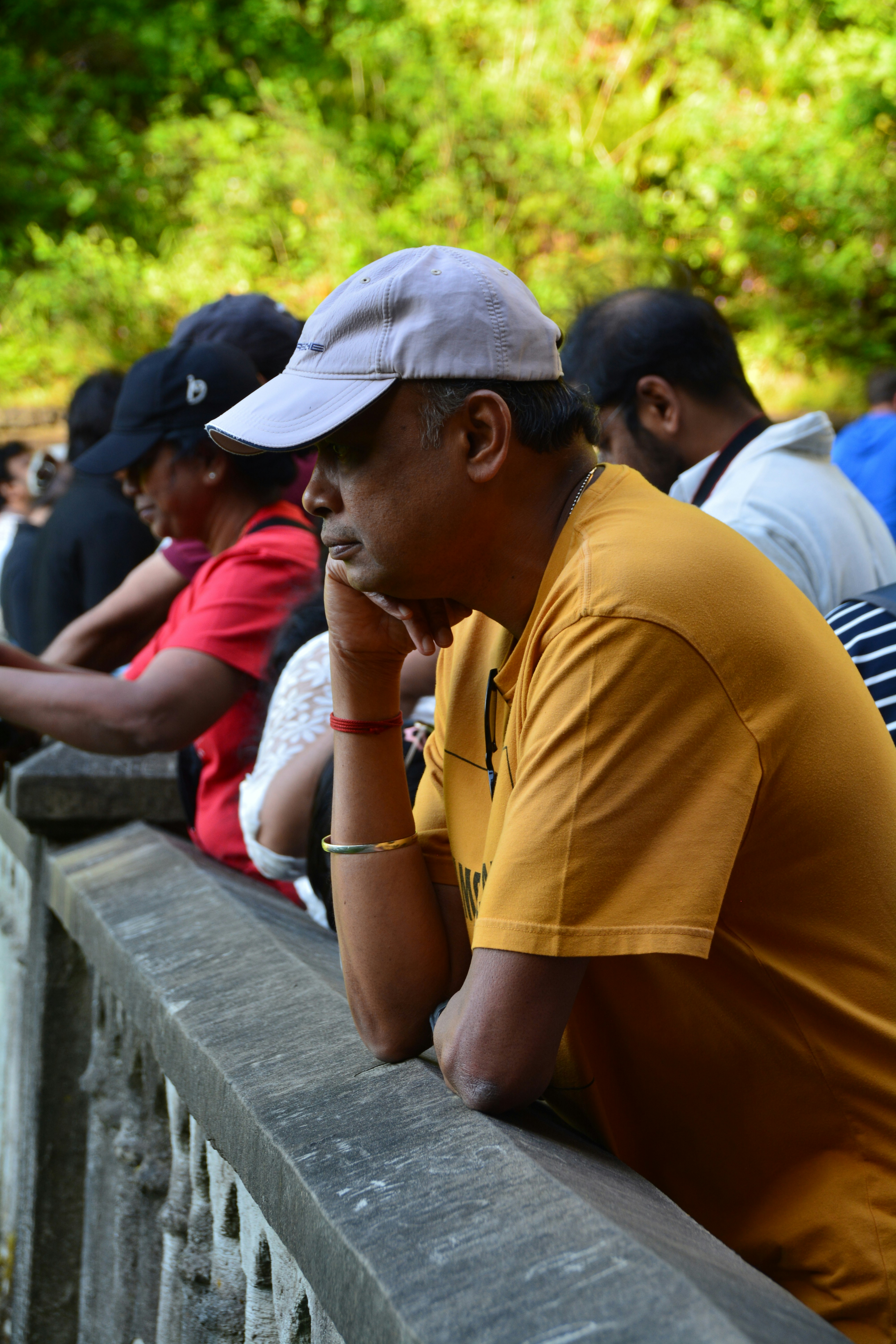 Man rests chin while looking off into the distance.