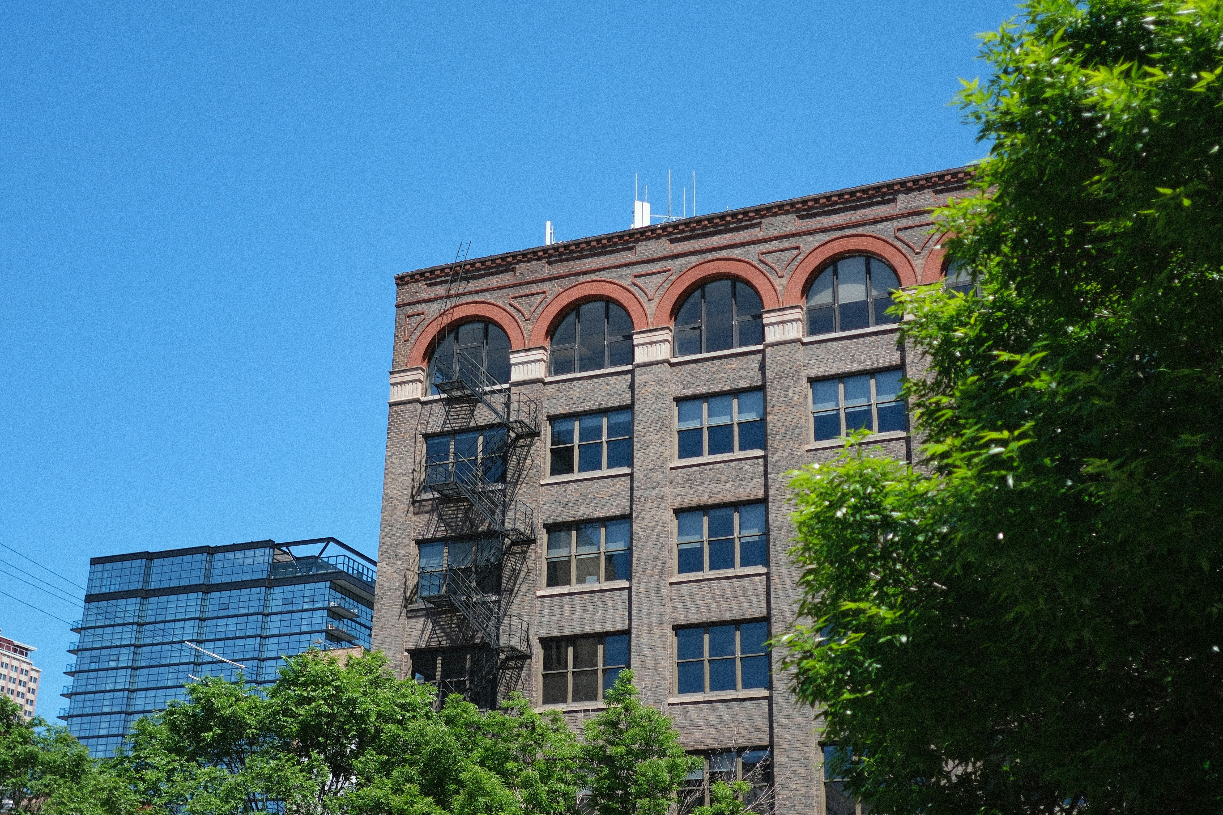Historic building exterior at 730 Hennepin Avenue with 8-story facade and modern loft windows - city place lofts minneapolis