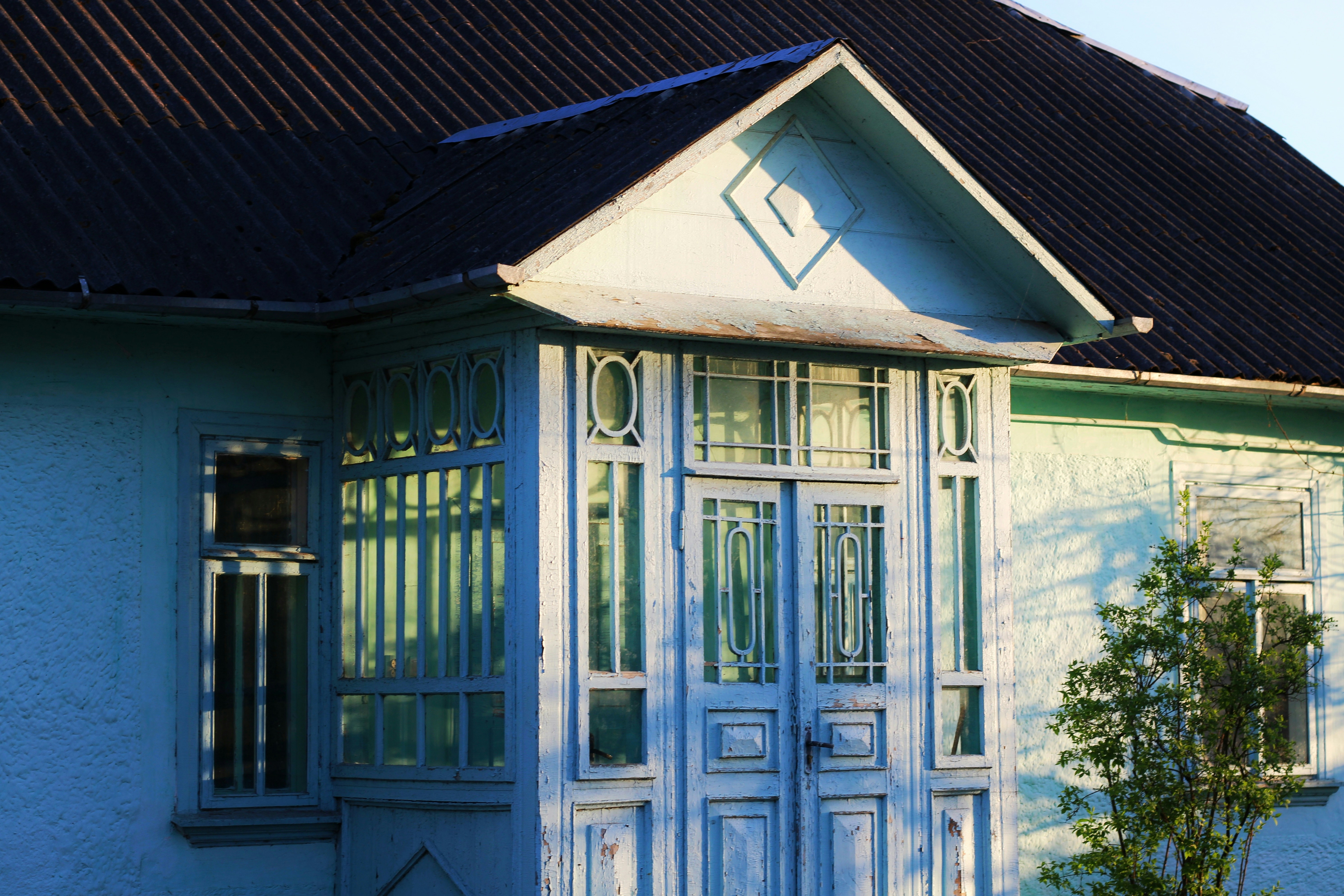 A blue house with intricate details is shown.