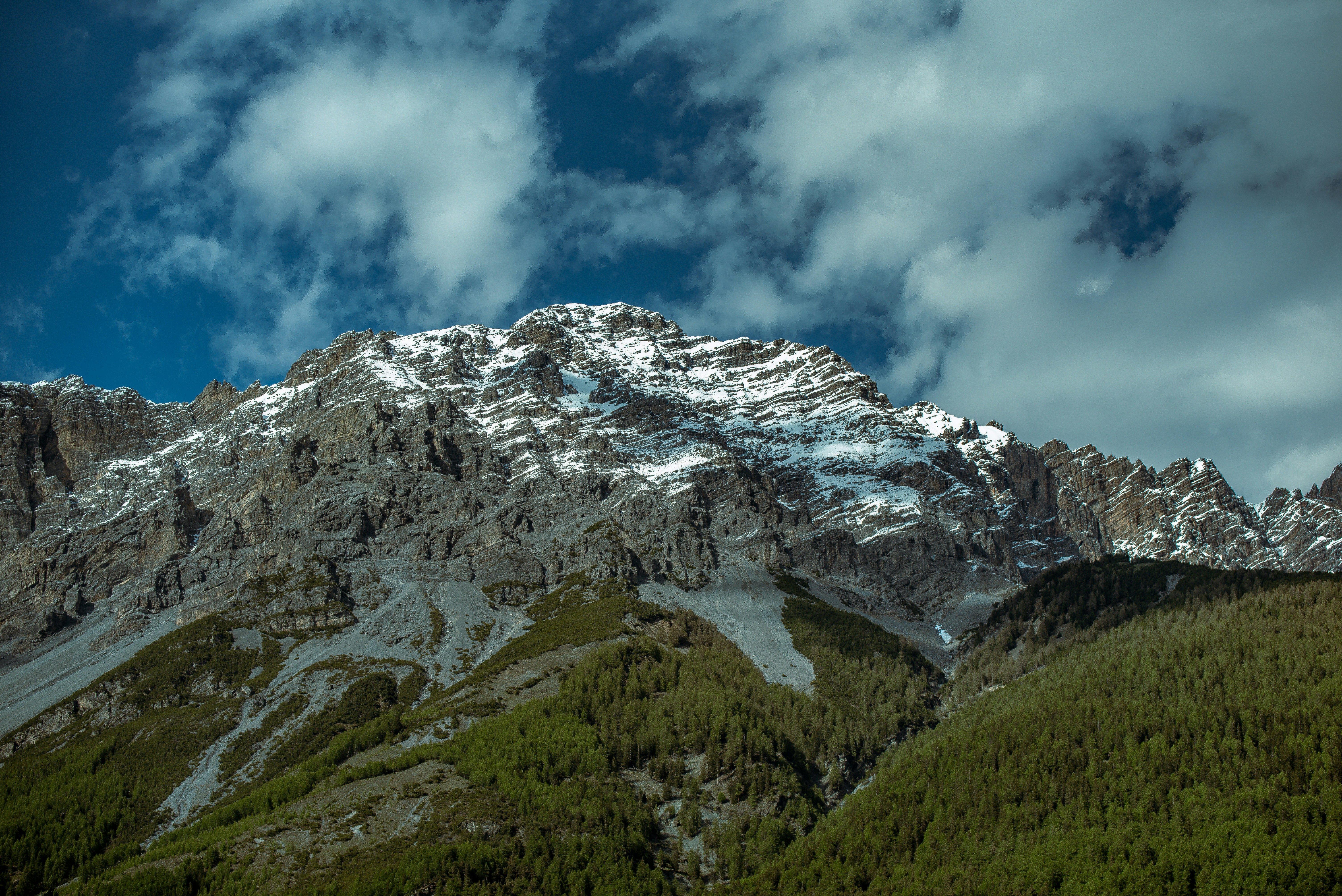 Snow-capped mountains rise under a cloudy sky.