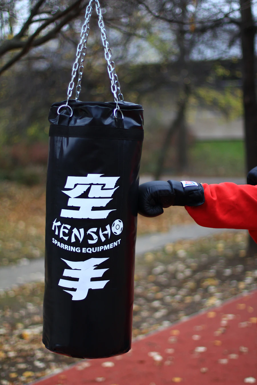 Boxing glove connecting with a heavy bag mid-punch