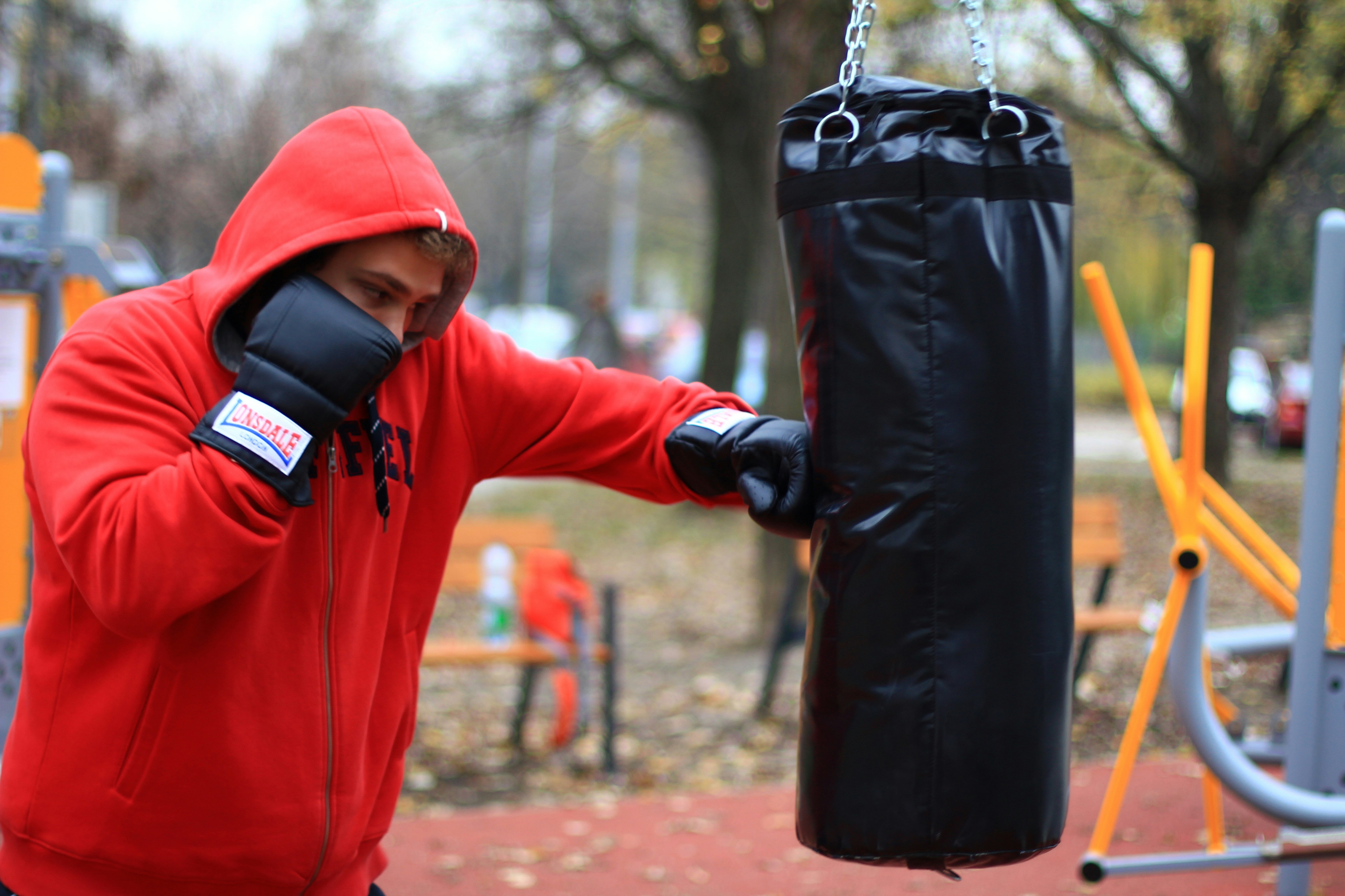 A boxer in motion demonstrating strength and control in a minimalist gym setting