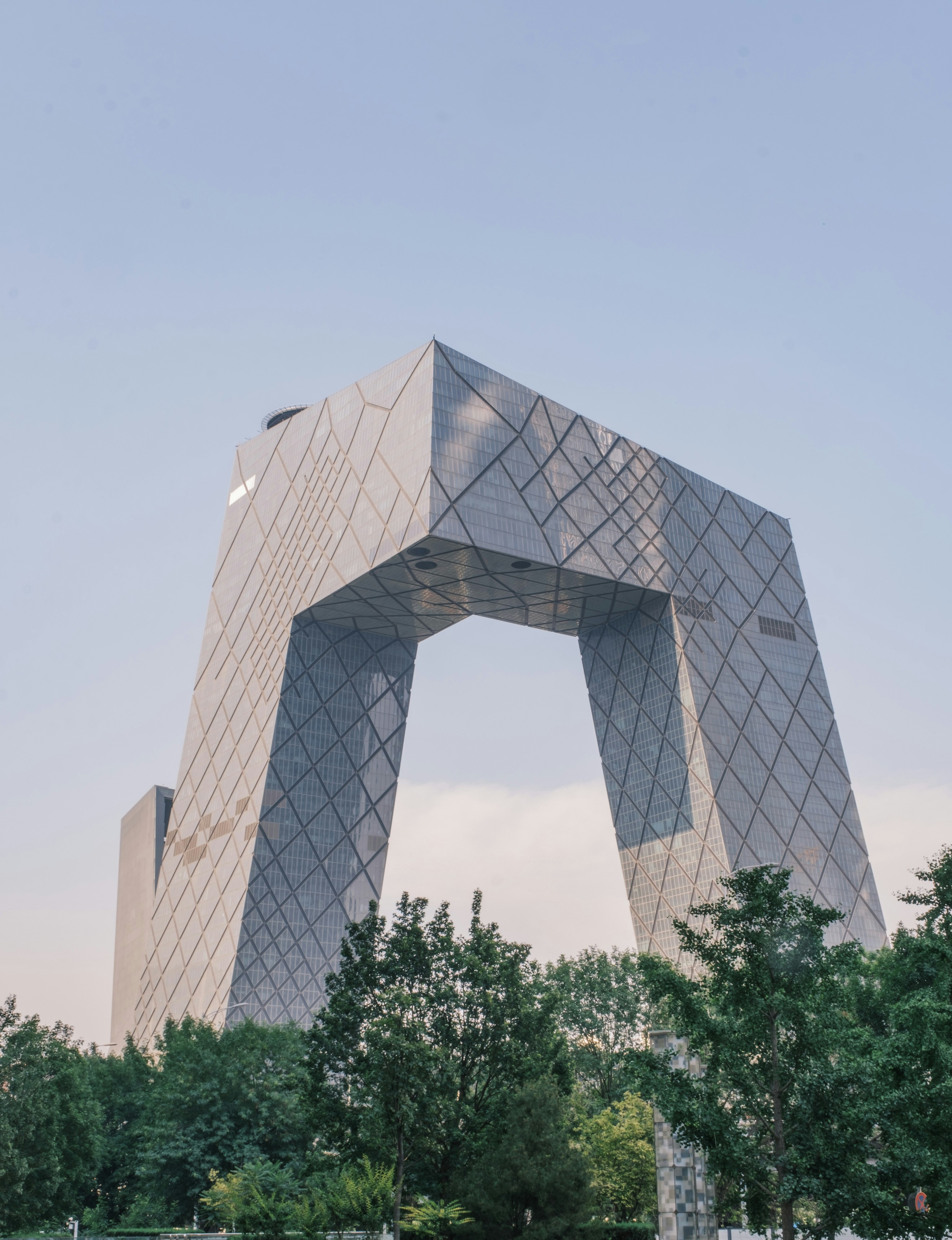 Here's a caption: a modern building with a distinctive shape. photo ...