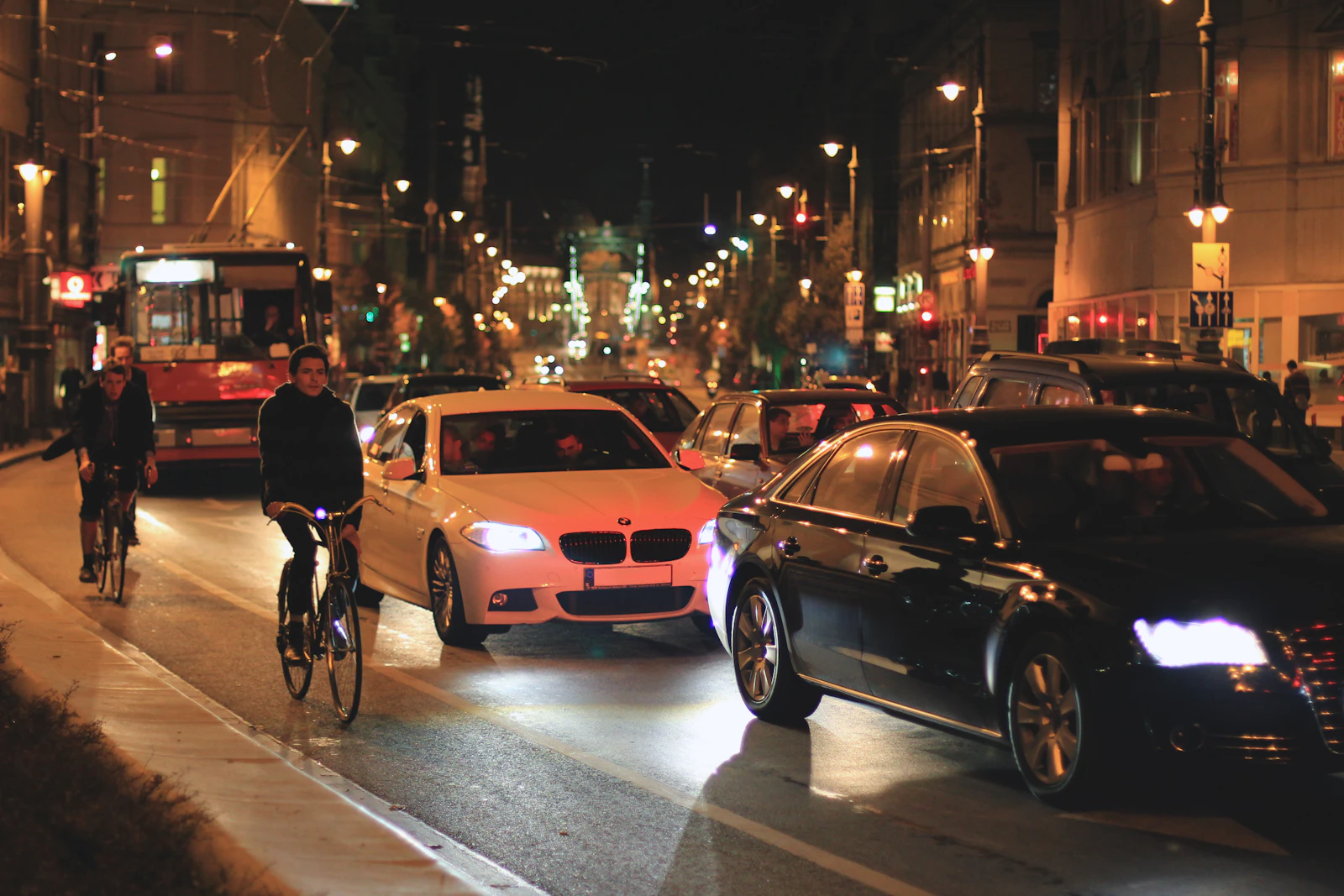 Cars and cyclists moving through Budapest after dark