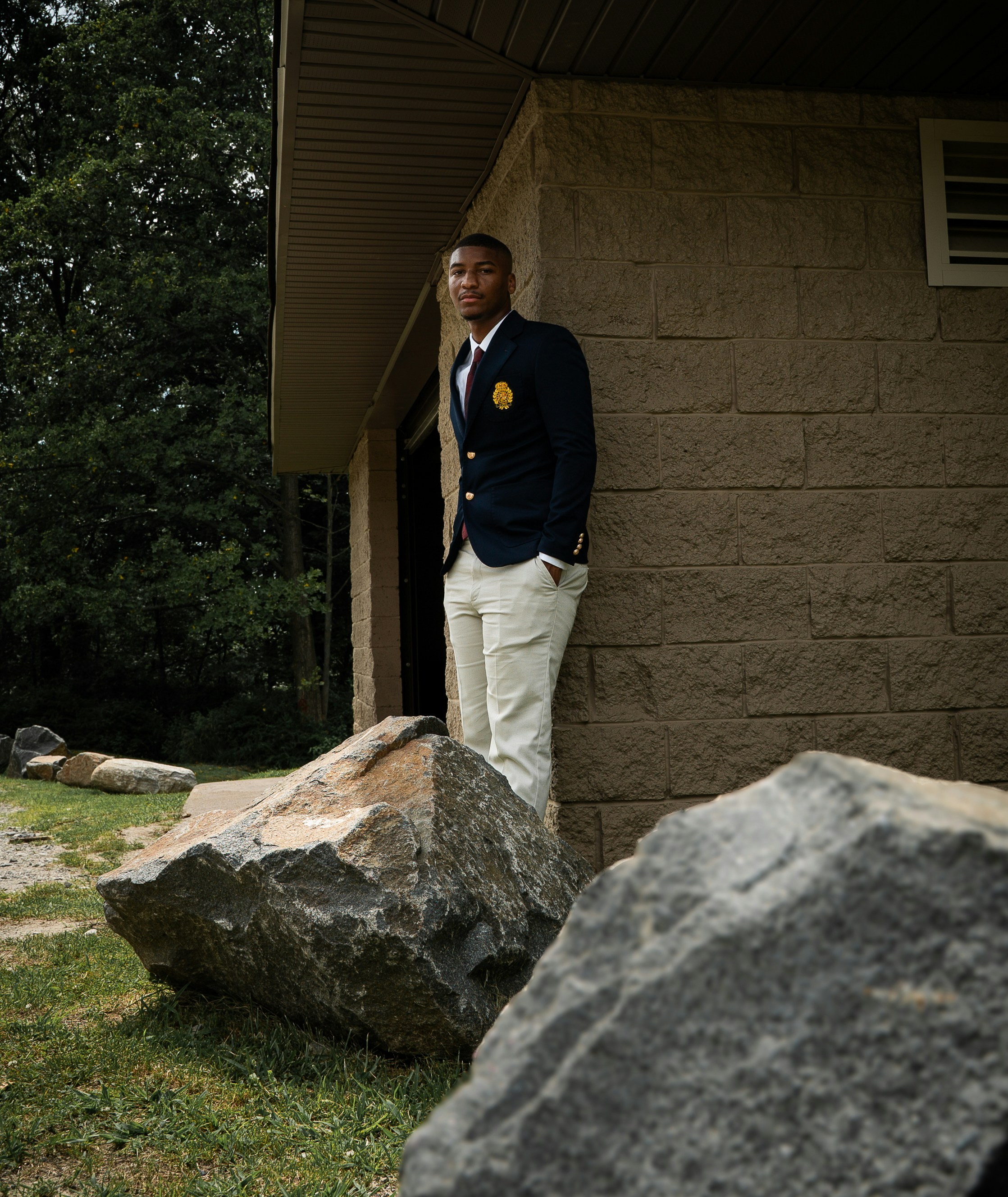 Stylish man poses near a stone building