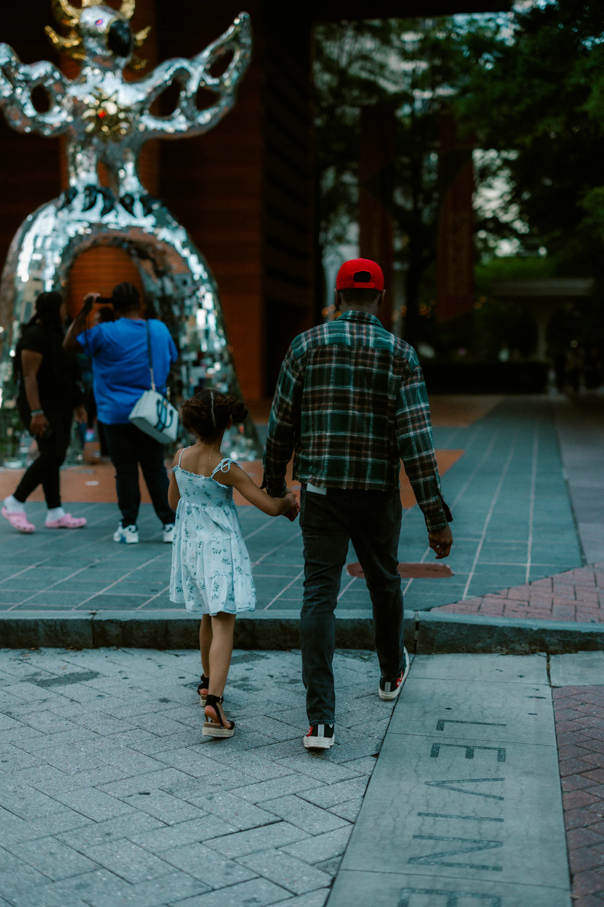 Father and daughter walking hand in hand
