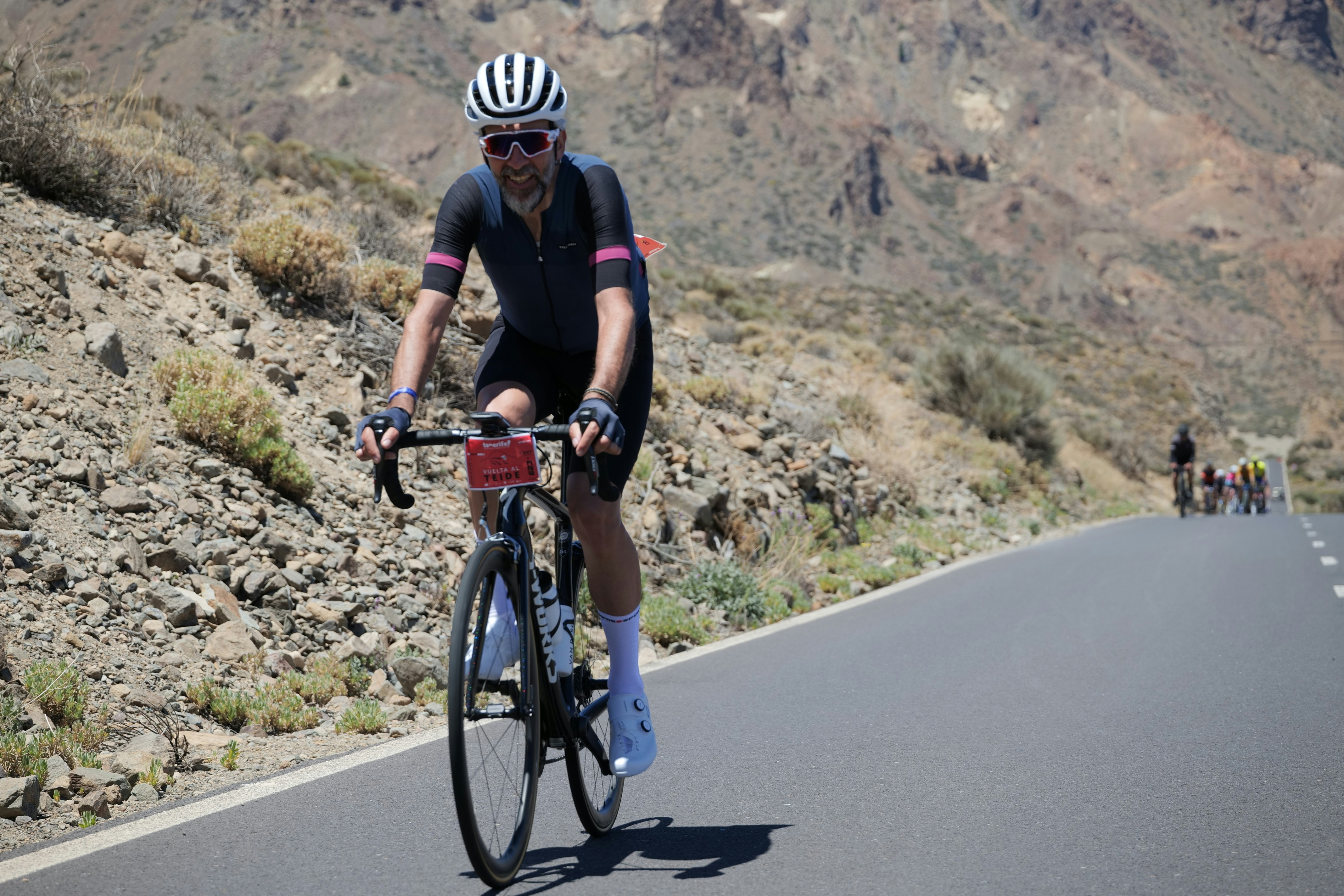 Cyclist rides uphill on a mountain road.