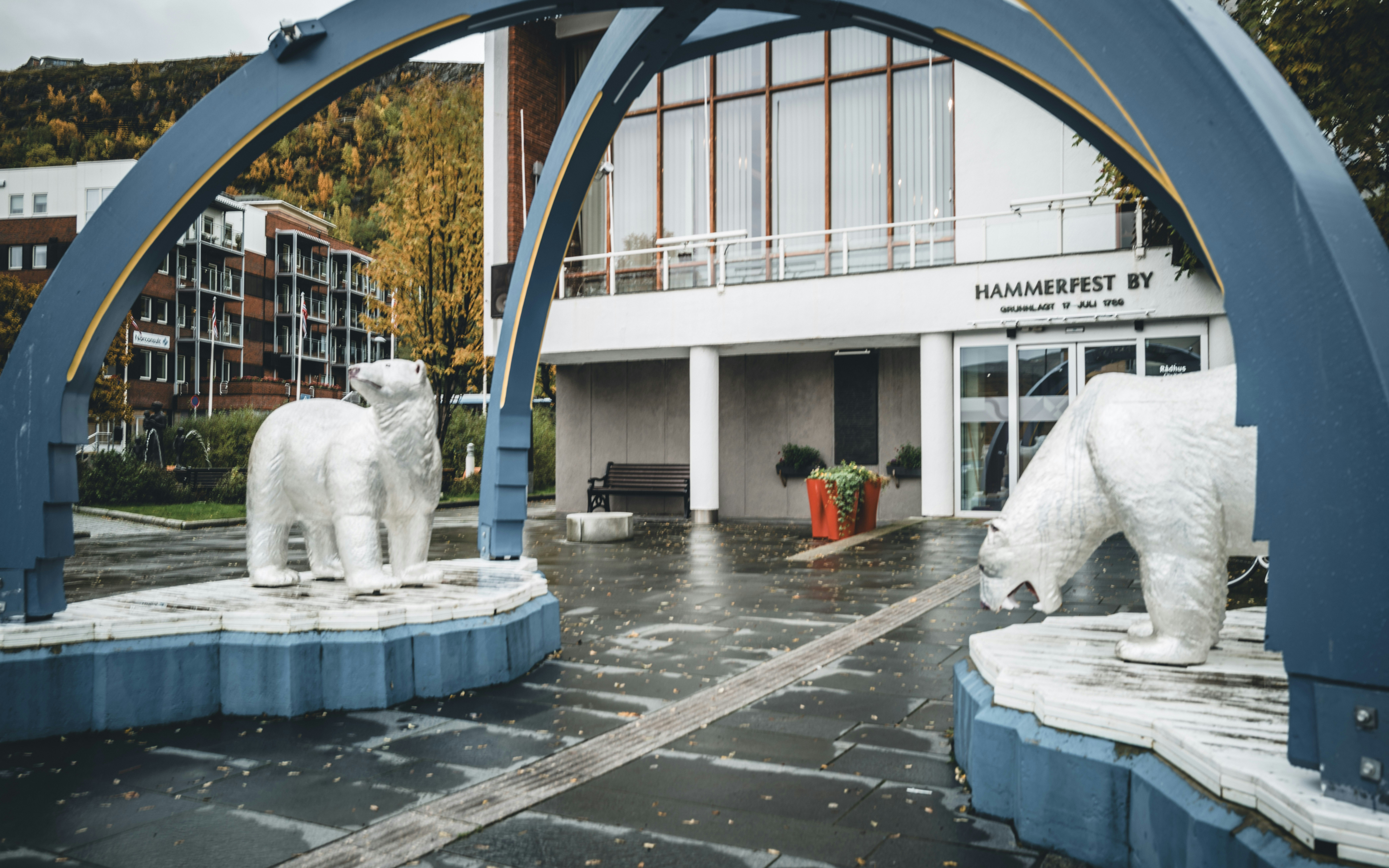 Sculptures of polar bears stand near a building.
