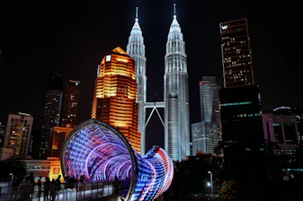The illuminated petronas towers stand tall at night.