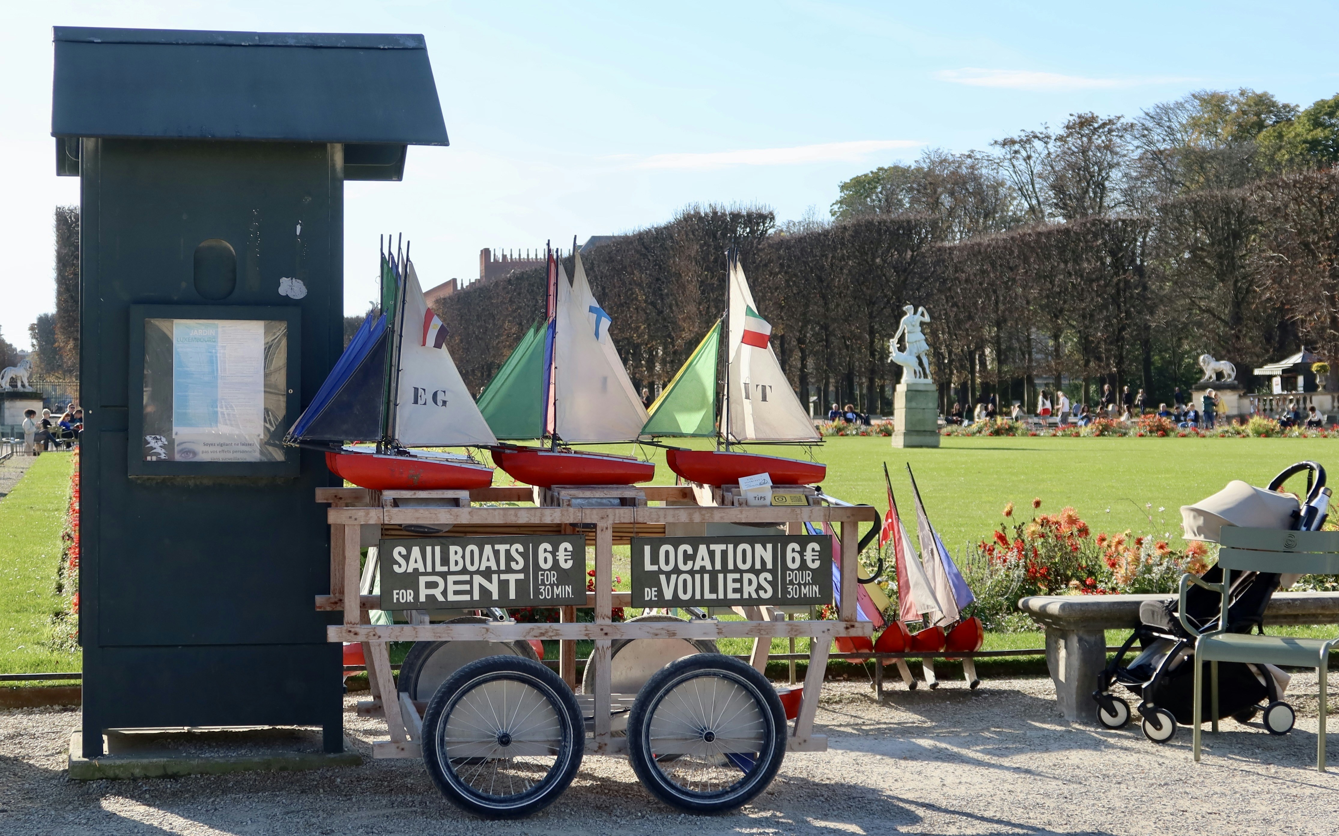 Sailboat rentals for kids by a park.