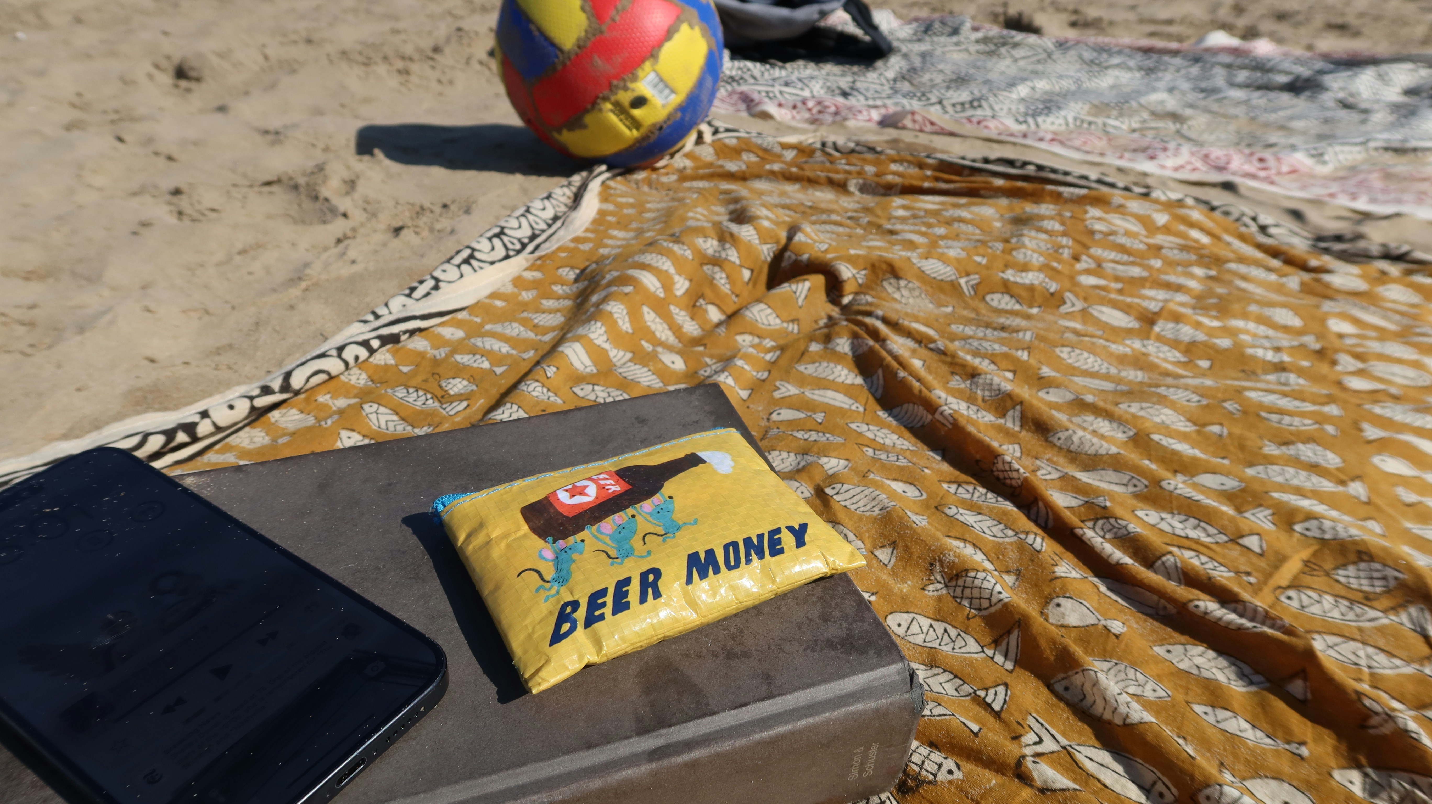 Beach day with a volleyball and beer money.