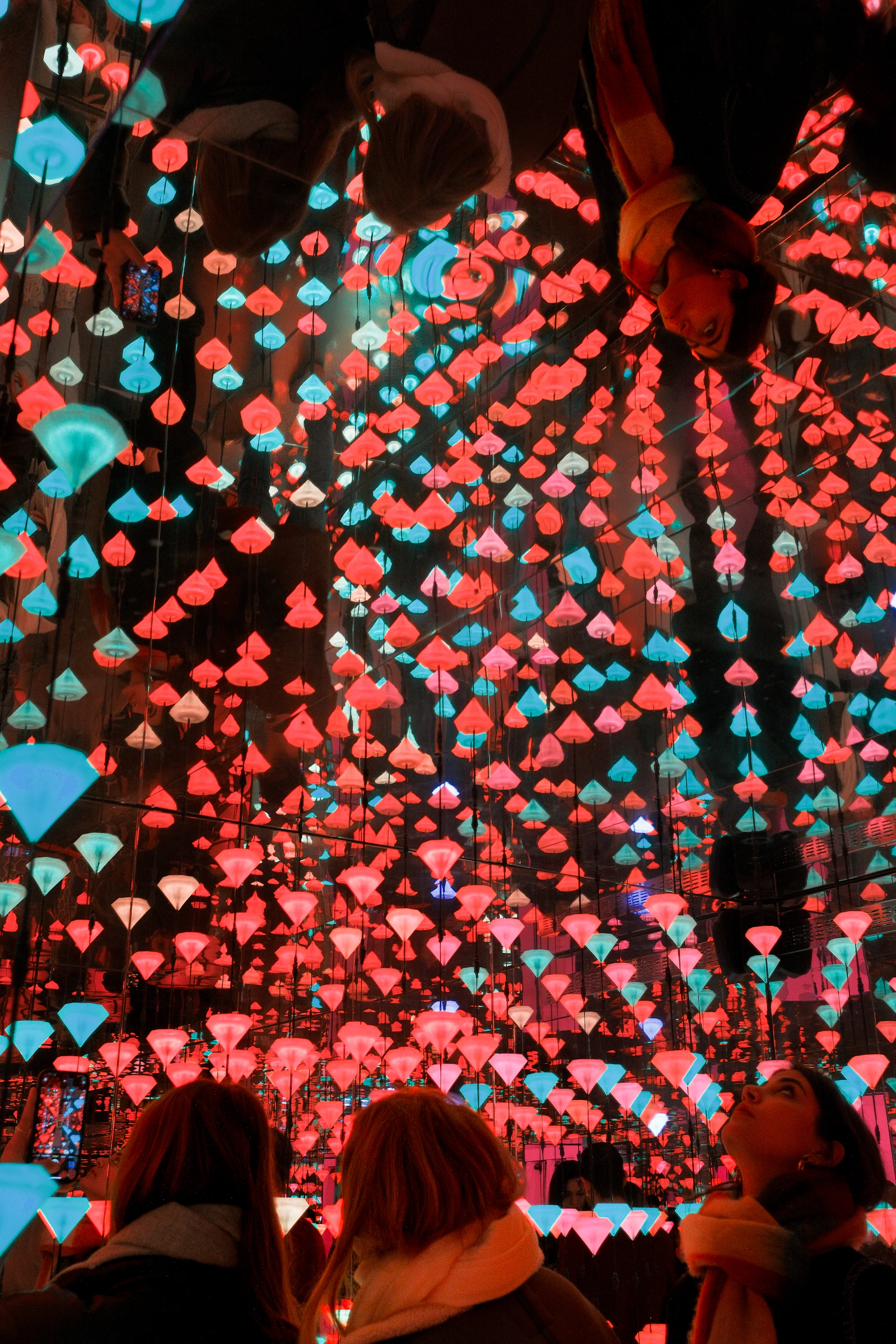 People immersed in a luminous interactive art environment