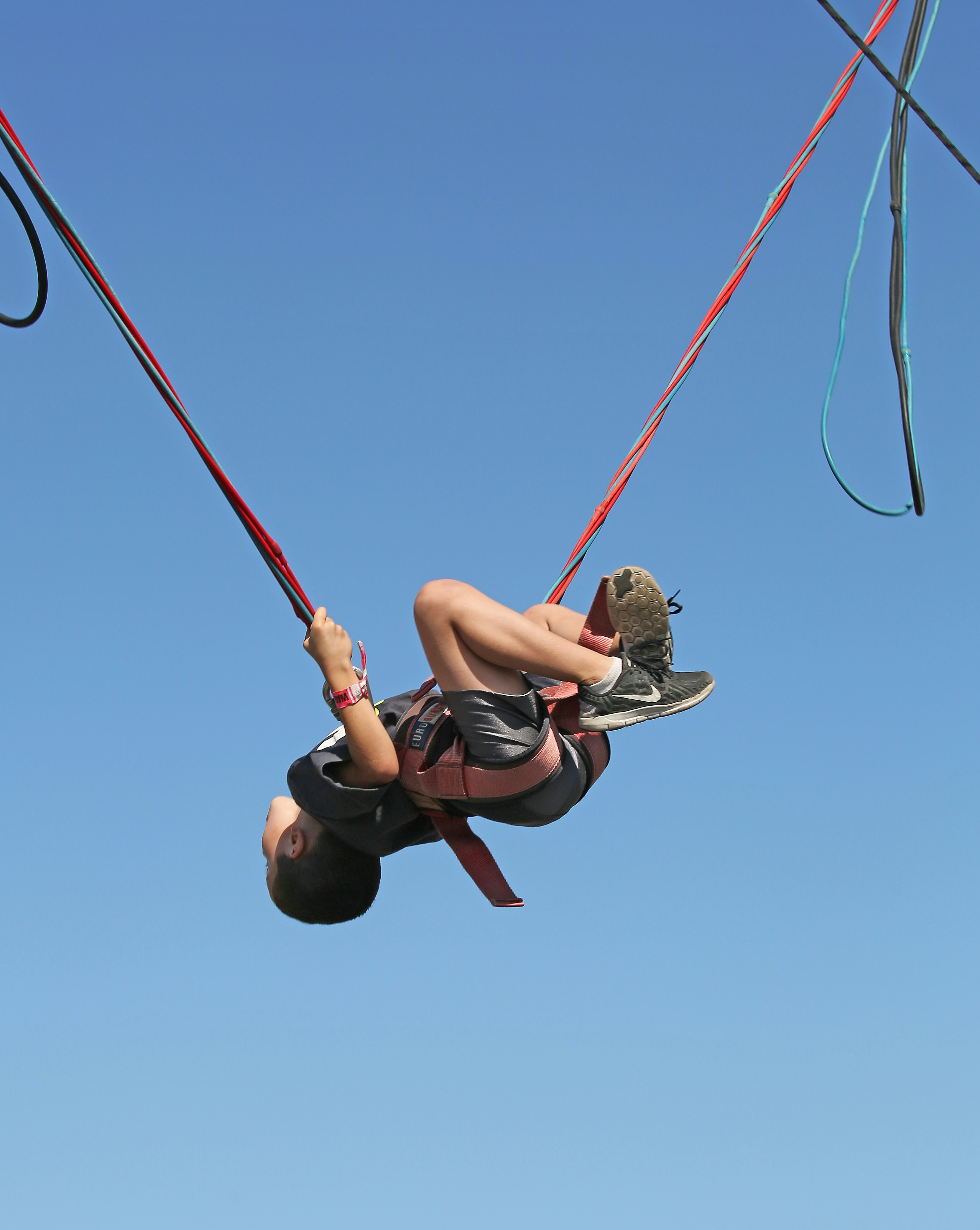 A person is bungee jumping into the air.