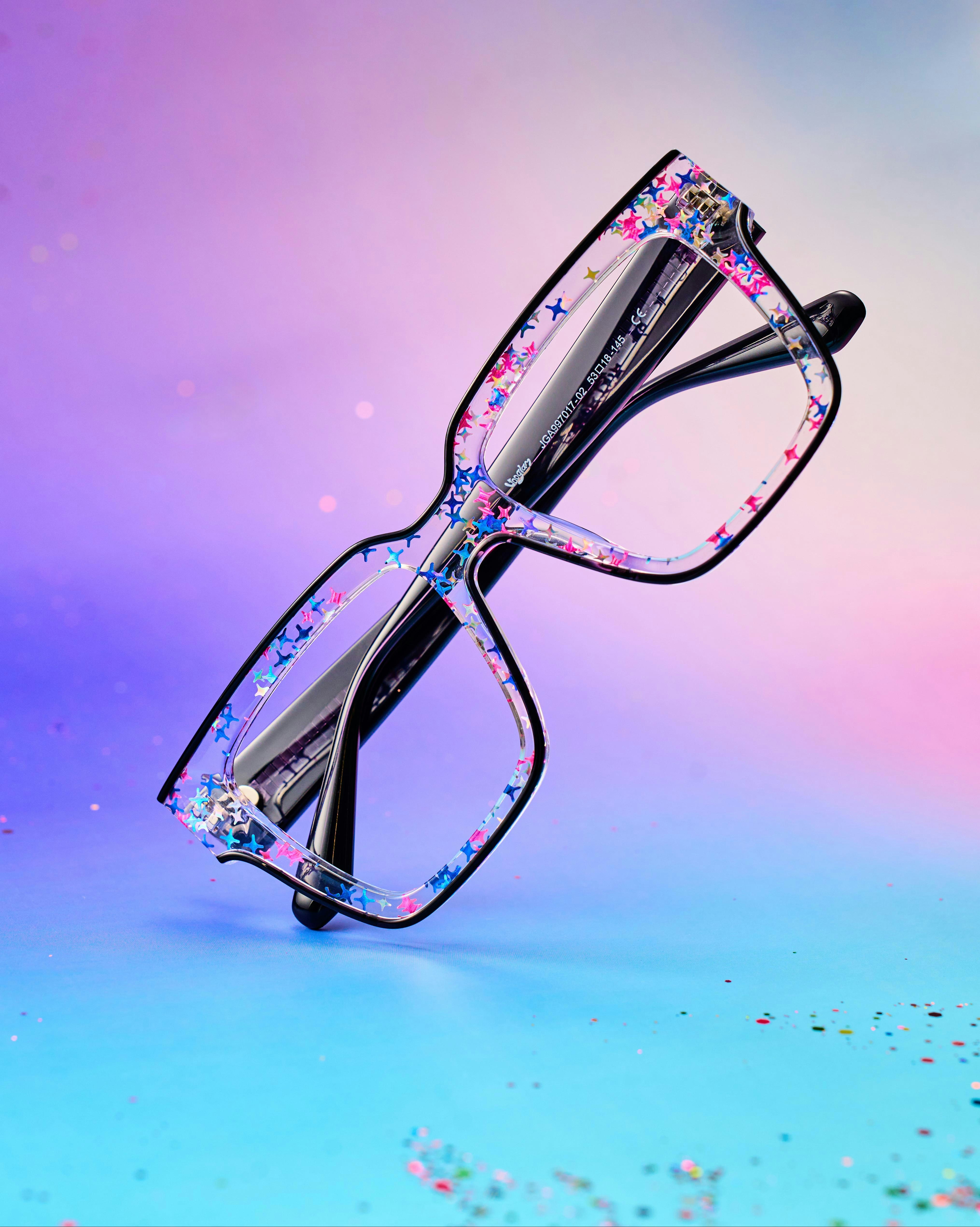 Stylish, colorful eyeglasses with glittery accents are displayed.