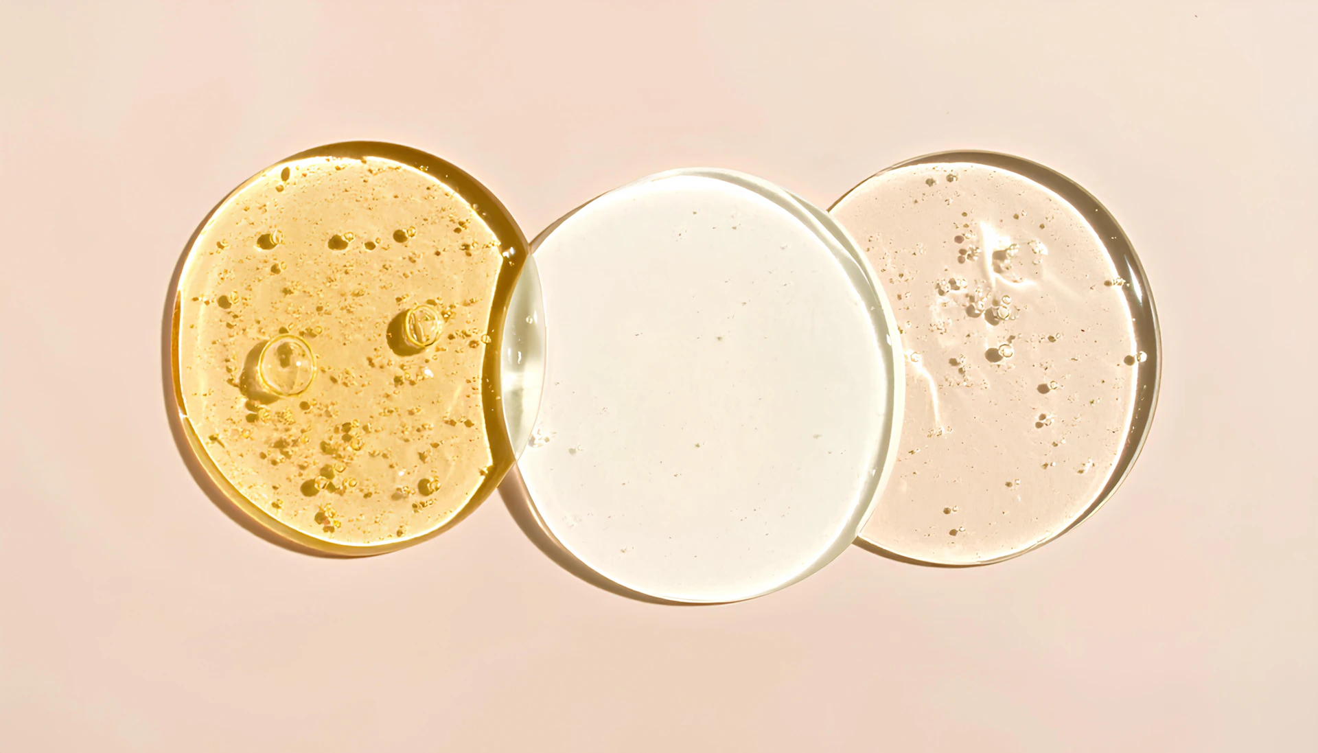 Three swirls of cosmetic liquid are displayed