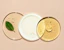 Cosmetic serums arranged on clear, circular plates