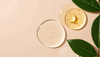 Skincare serums and leaves on a neutral background.