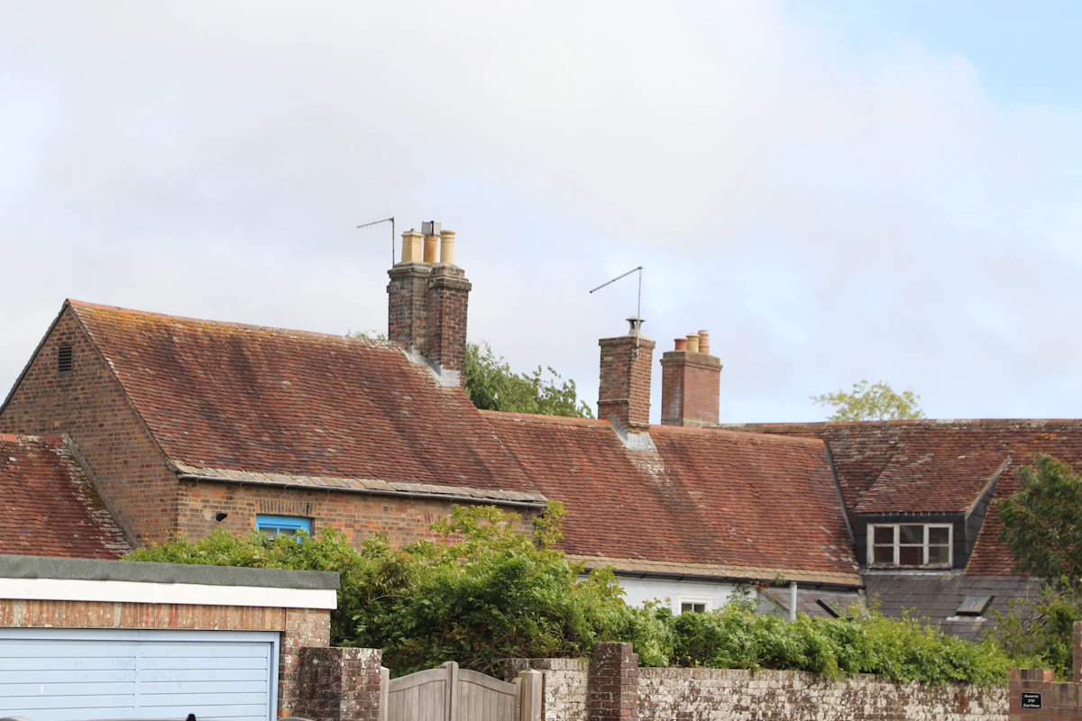 Traditional British red-brick houses with tiled roofs and chimneys