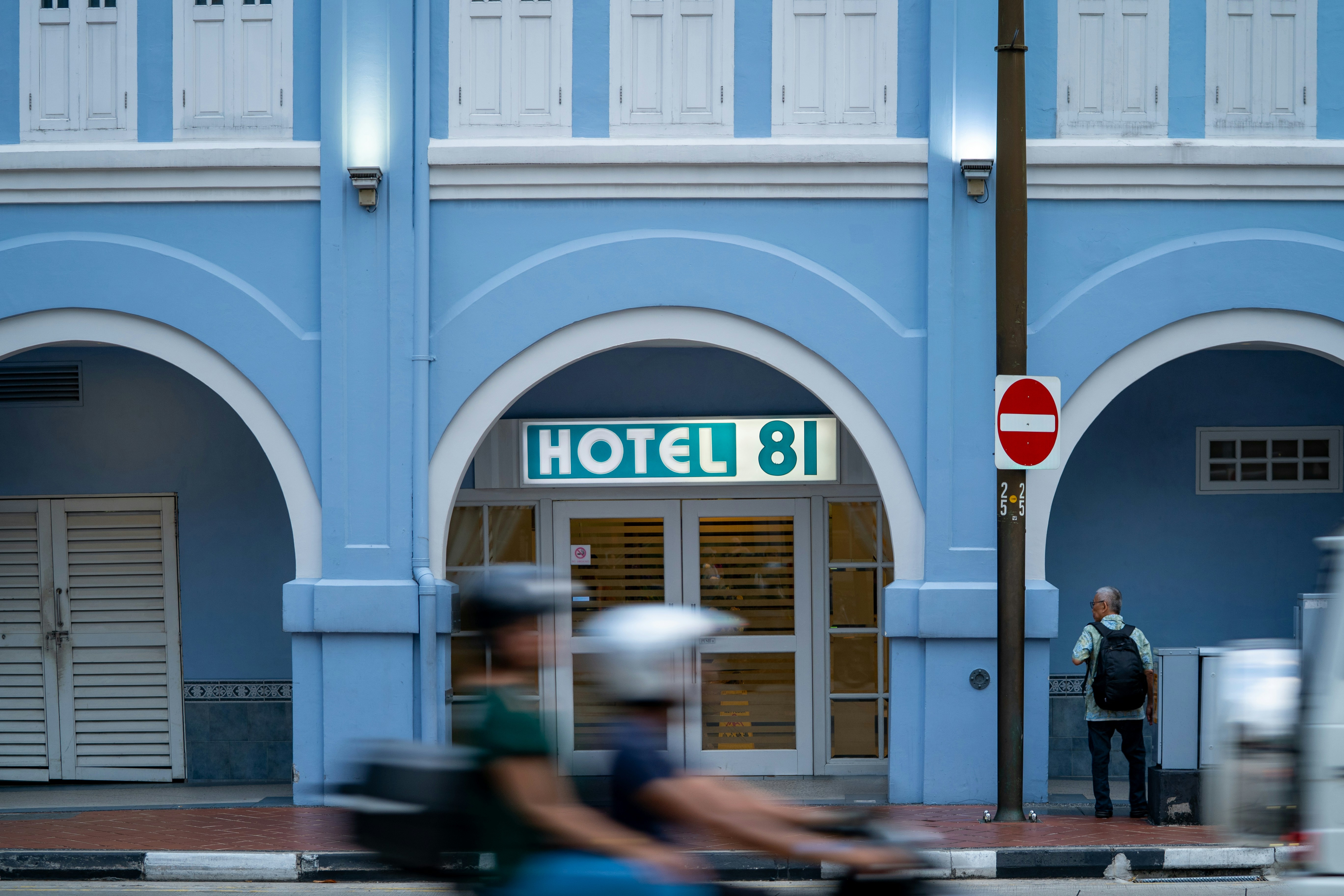 Hotel 81 entrance with blurred traffic below.