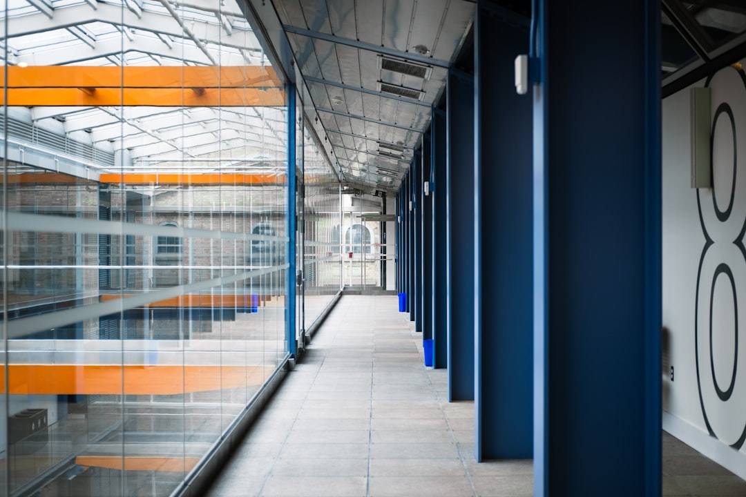 A modern building interior with long hallway.,