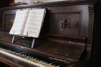 An antique piano with sheet music is displayed.