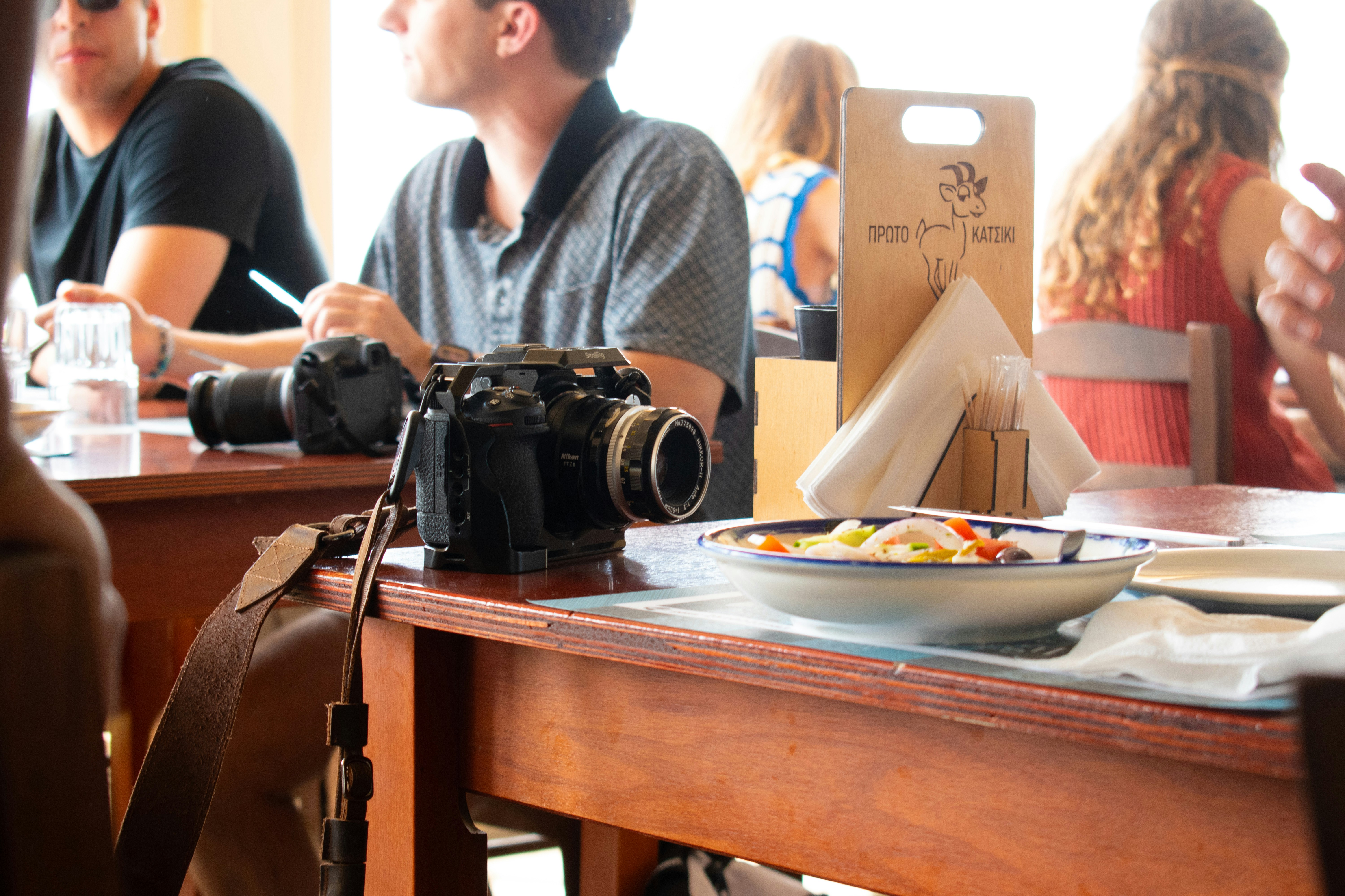 A camera sits on a table in a restaurant. photo – Free White Image on ...