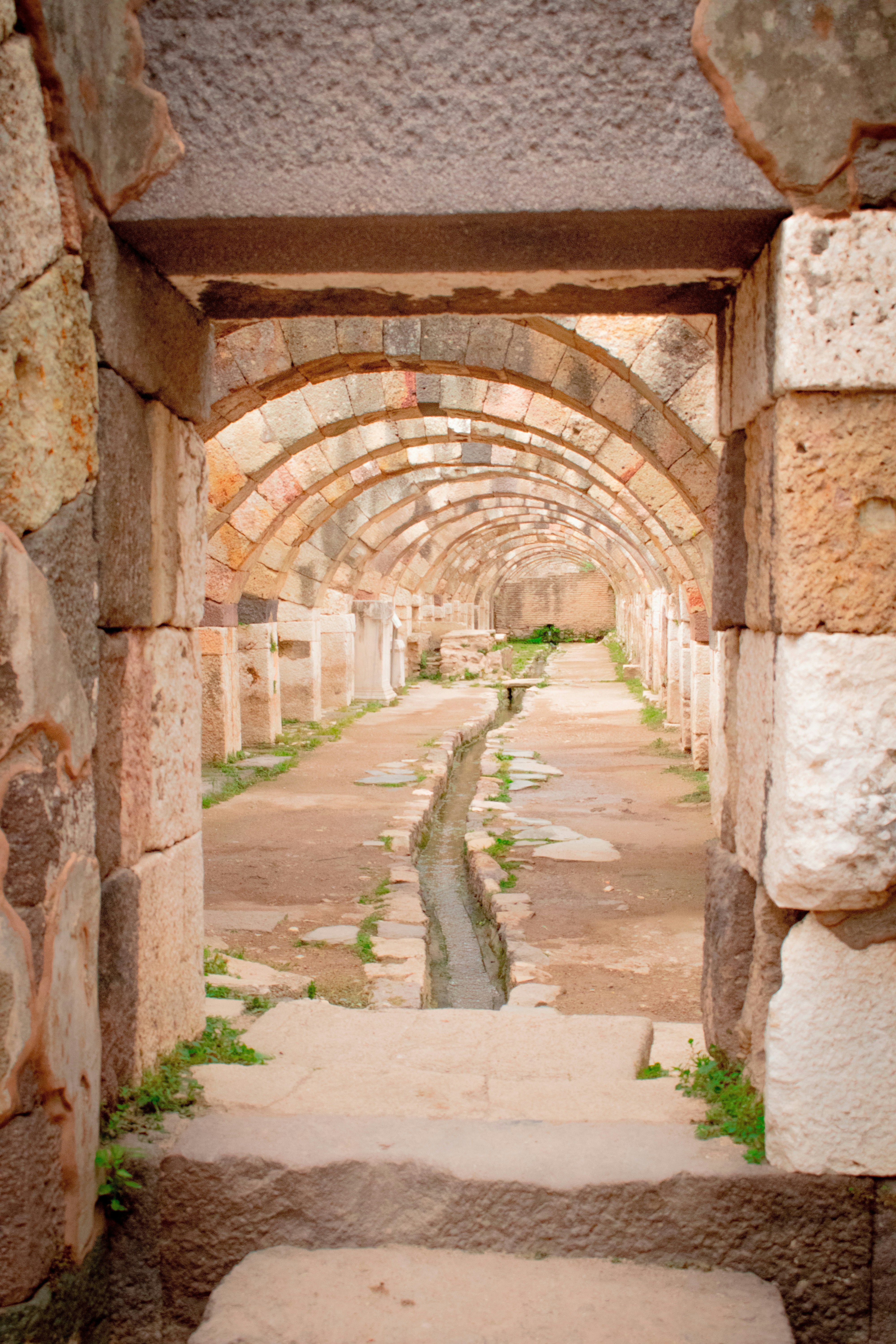 Ancient ruins reveal arched walkways and a waterway.