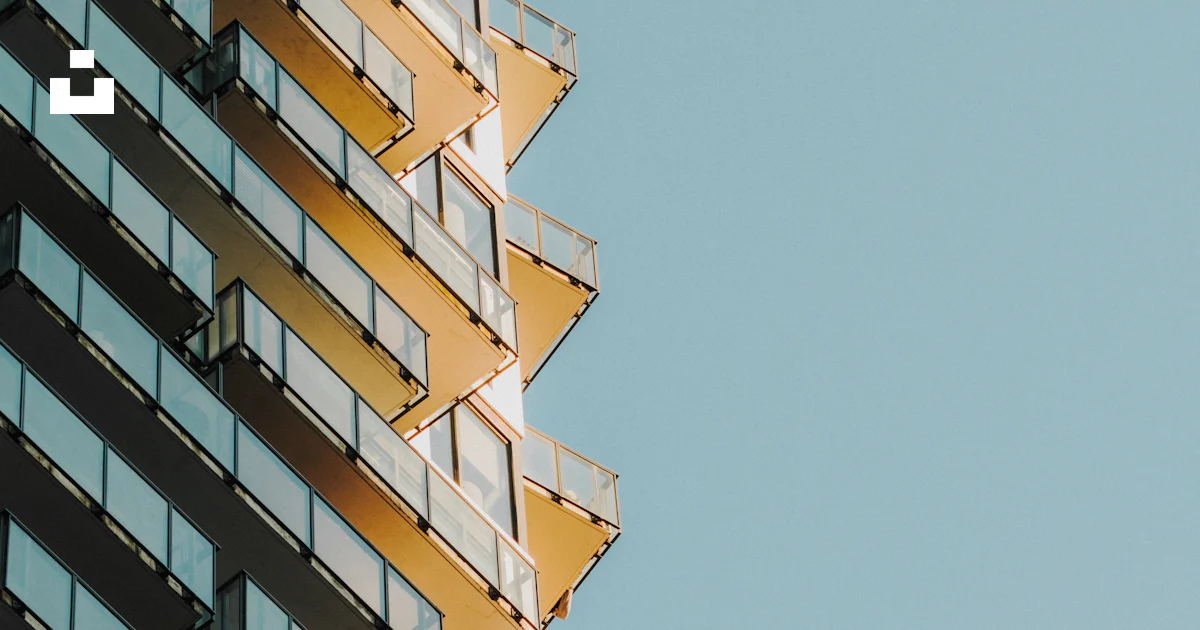 Modern Apartment Building With Many Balconies Against A Blue Sky Photo modern-apartment-building-with-many-balconies-against-a-blue-sky-photo