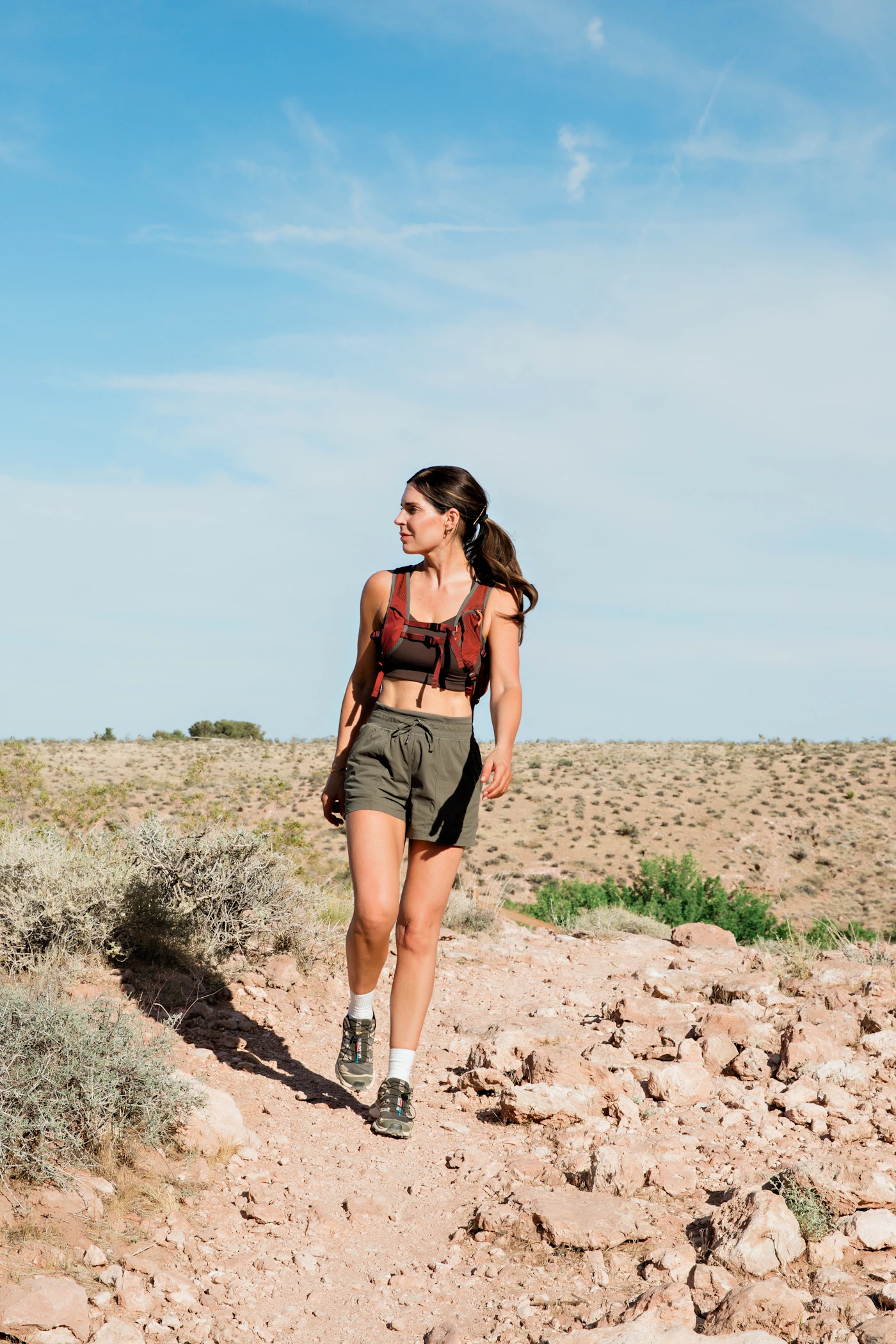 Woman hiking alone on a scenic trail, representing new experiences and independence after a breakup