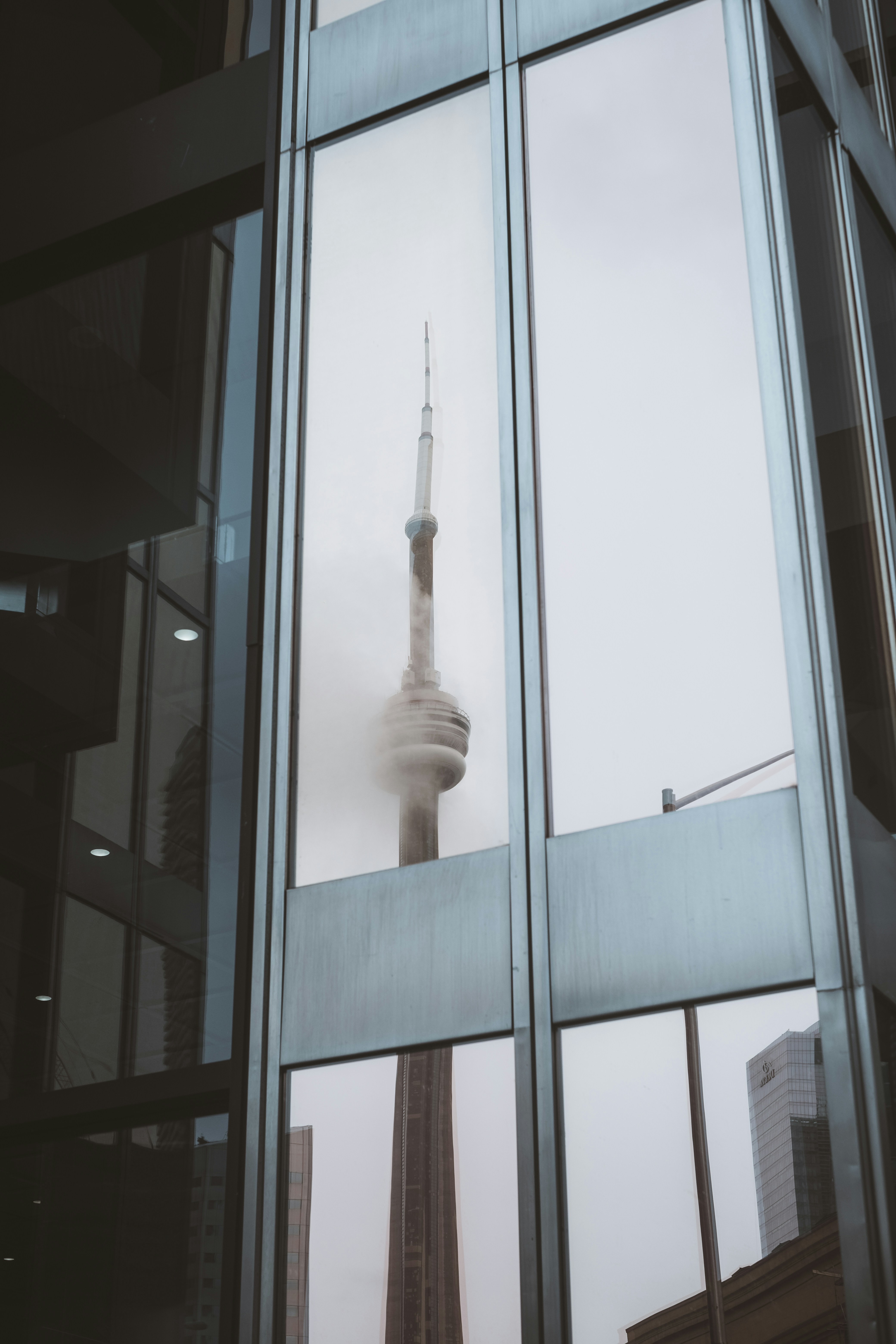 Cn tower reflected in a building's window.